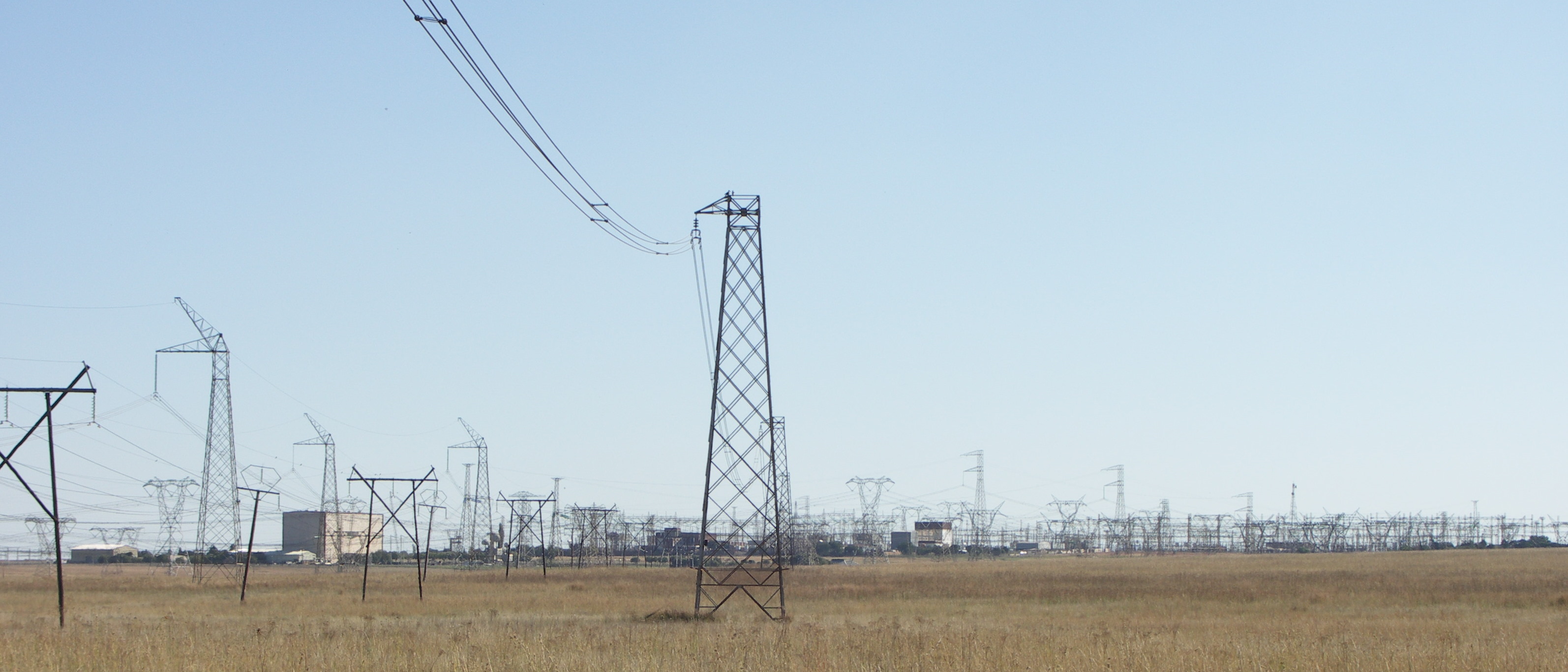 The Apollo HVDC converter station and HVDC and HVAC distribution cables running to it. Photo taken from within Rietvlei Nature Reserve, South Africa.
Tall pylons on the left are part of the Cahora Bassa HVDC line.
