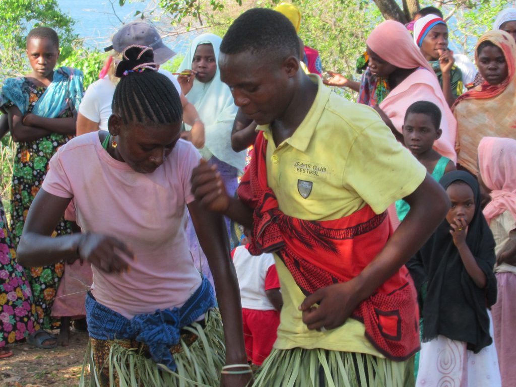 Residents of Kilwa Kisiwani Island, Tanzania, perform a dance for overseas visitors.