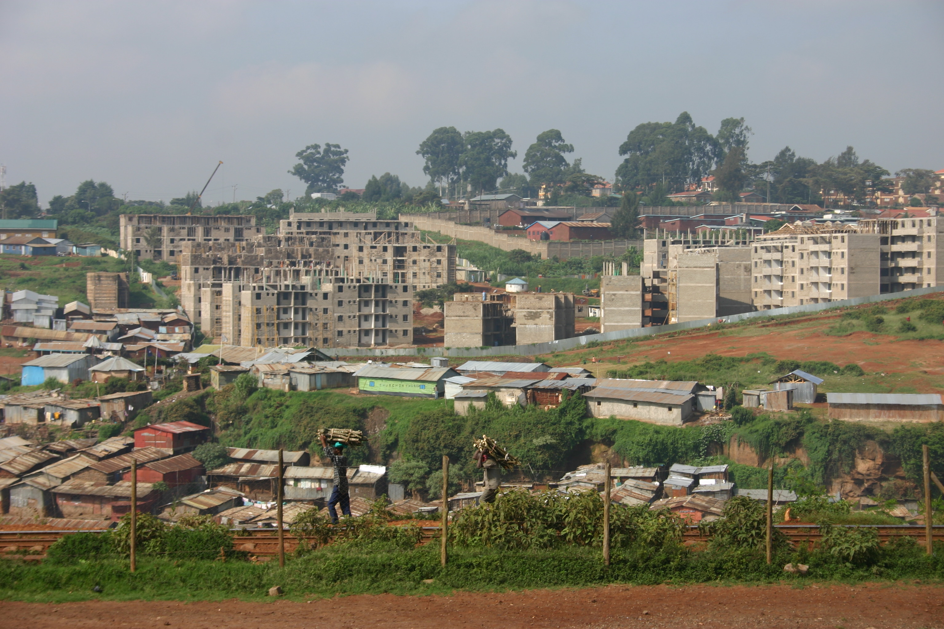 those high rises in the back are being built by the government in the hopes of eventually tearing down Kibera. However, the rent in the high rises are far too expensive for most residents. Welcome to gentrification, folks. It's in Africa, too. Original description by: genvessel