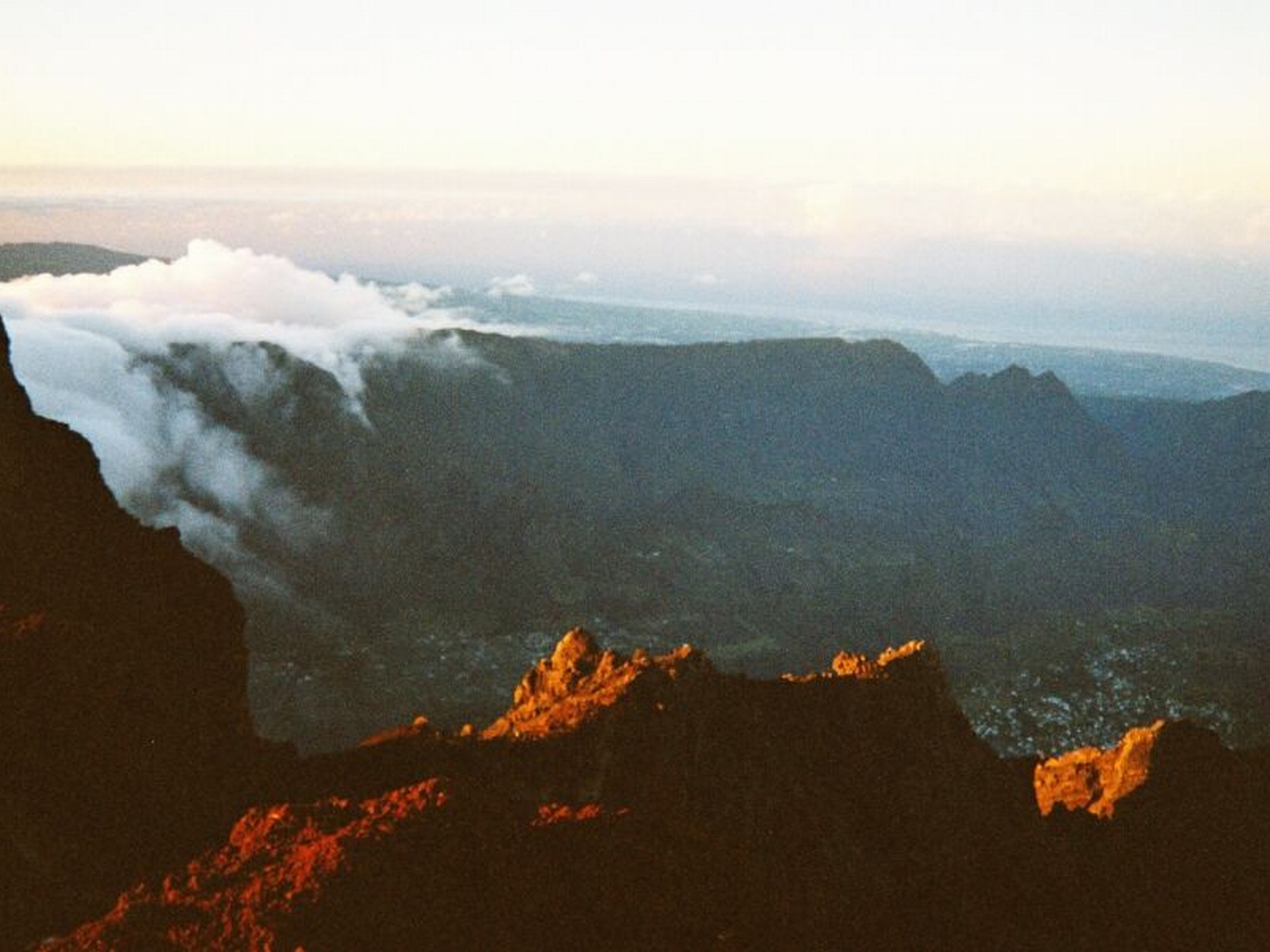 The Cirque de Cilaos, a volcanic caldera and community on Réunion, an overseas 'Departement' of France. Seen from the summit of the Piton des Neiges at dawn, looking southwards.