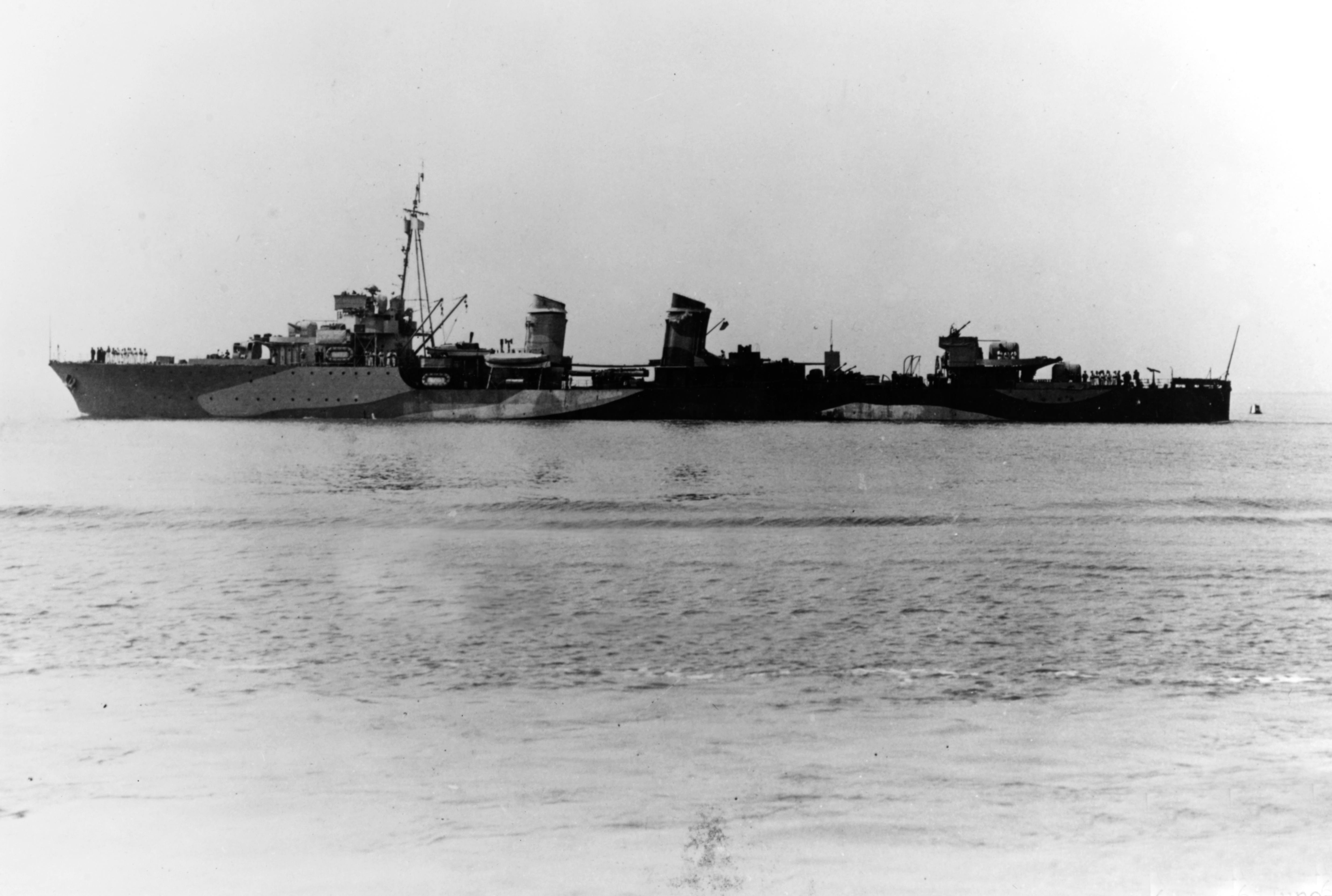 The Free French destroyer Léopard on 6 June 1942, following refit in the United Kingdom in which her forward stack and boilers were removed, fuel stowage increased and additional anti-aircraft guns fitted. Note her British-style pattern camouflage.