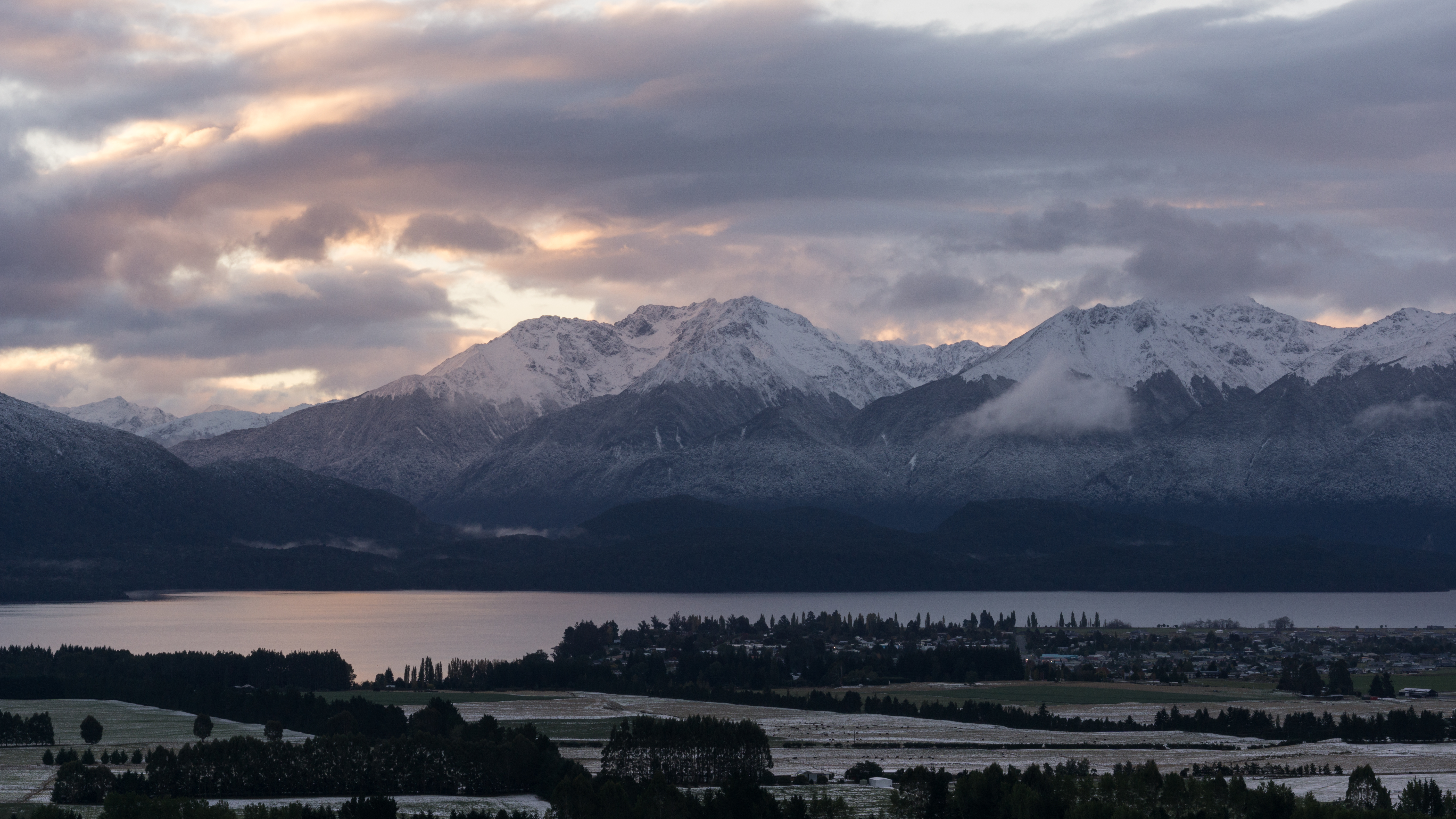 Te Anau with the Murchison Mountains in the background. Taken at dusk on the first day of snow fall in 2015.