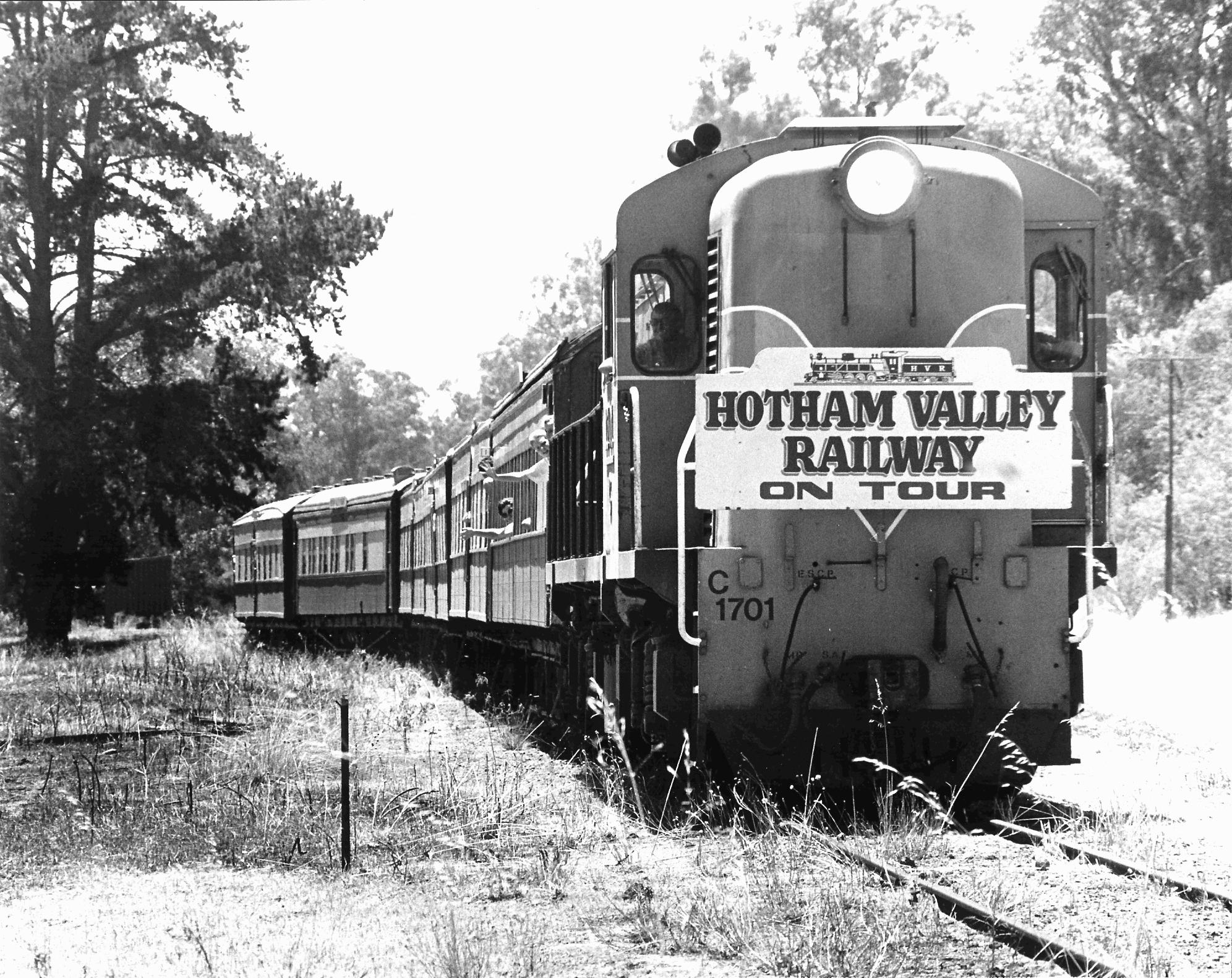 Western Australian Government Railways (WAGR) C class diesel-electric locomotive no C 1701, in Westrail orange and blue livery, passes through Wonnerup with a Hotham Valley Railway charter service that was also the last passenger train to Busselton, Western Australia.