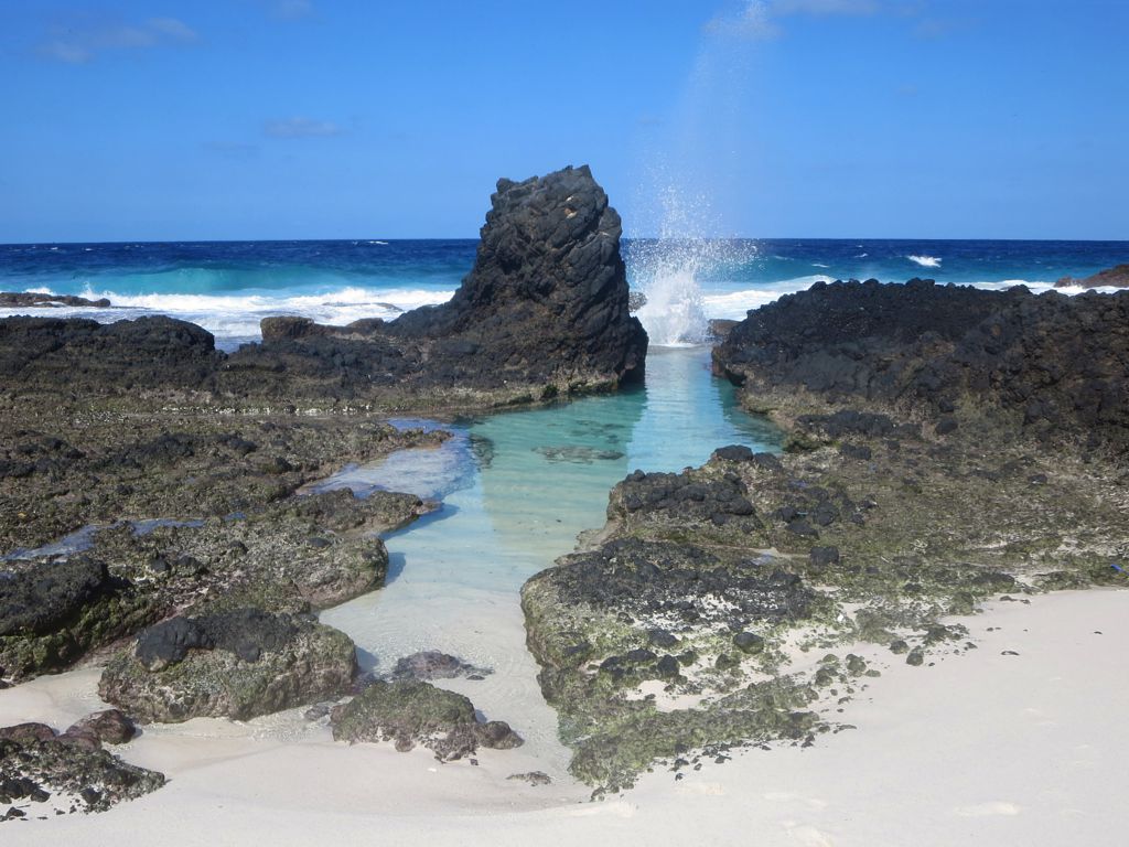 Basalt rock and coral sand combine to create an idyllic bathing pool at Dolly Beach in Christmas Island National Park, Australia.