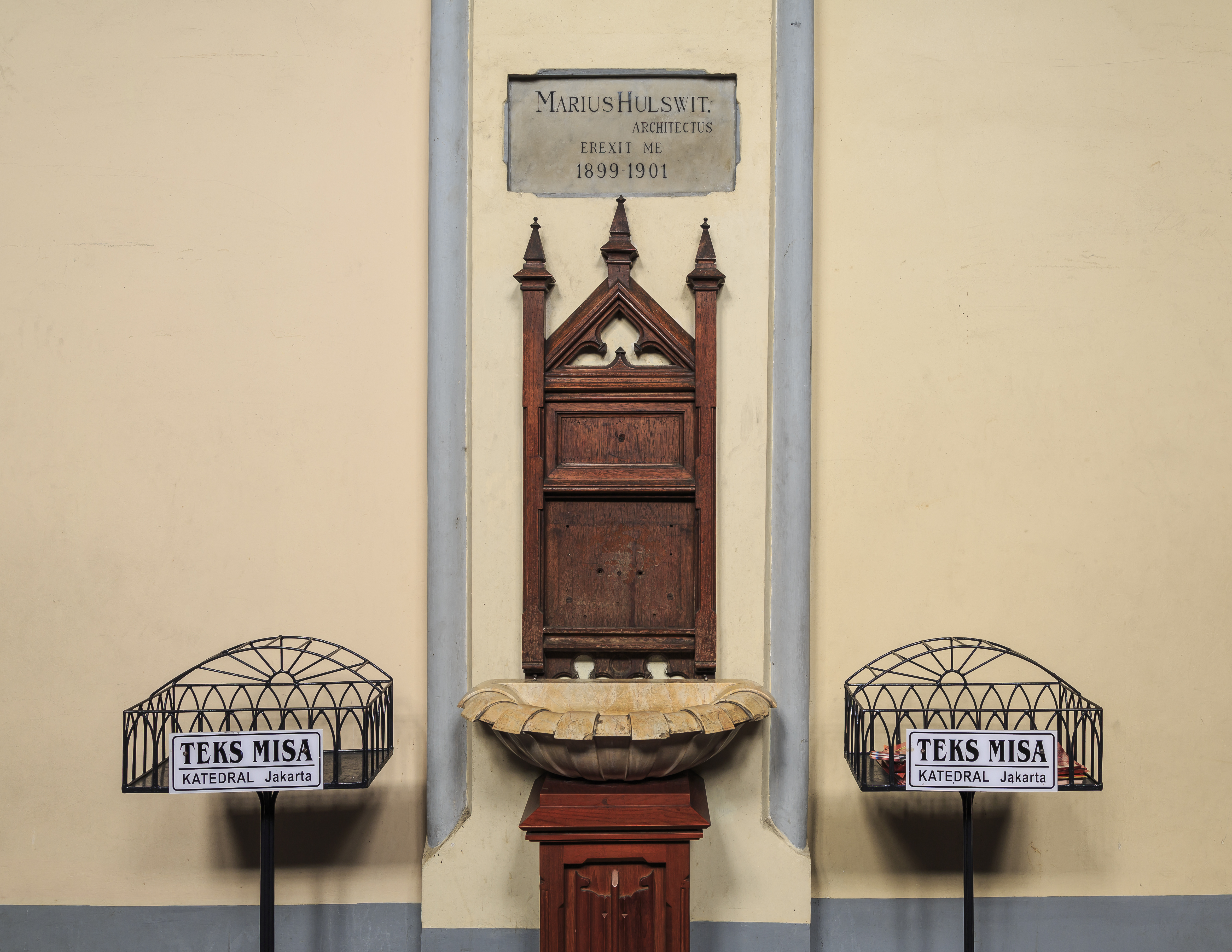 Jakarta, Indonesia: Stoup at the main entrance of Jakarta Cathedral with a memorial stone to Marius Hulswit, the dutch architect which finalized the cathedral in the years 1899 to 1901.