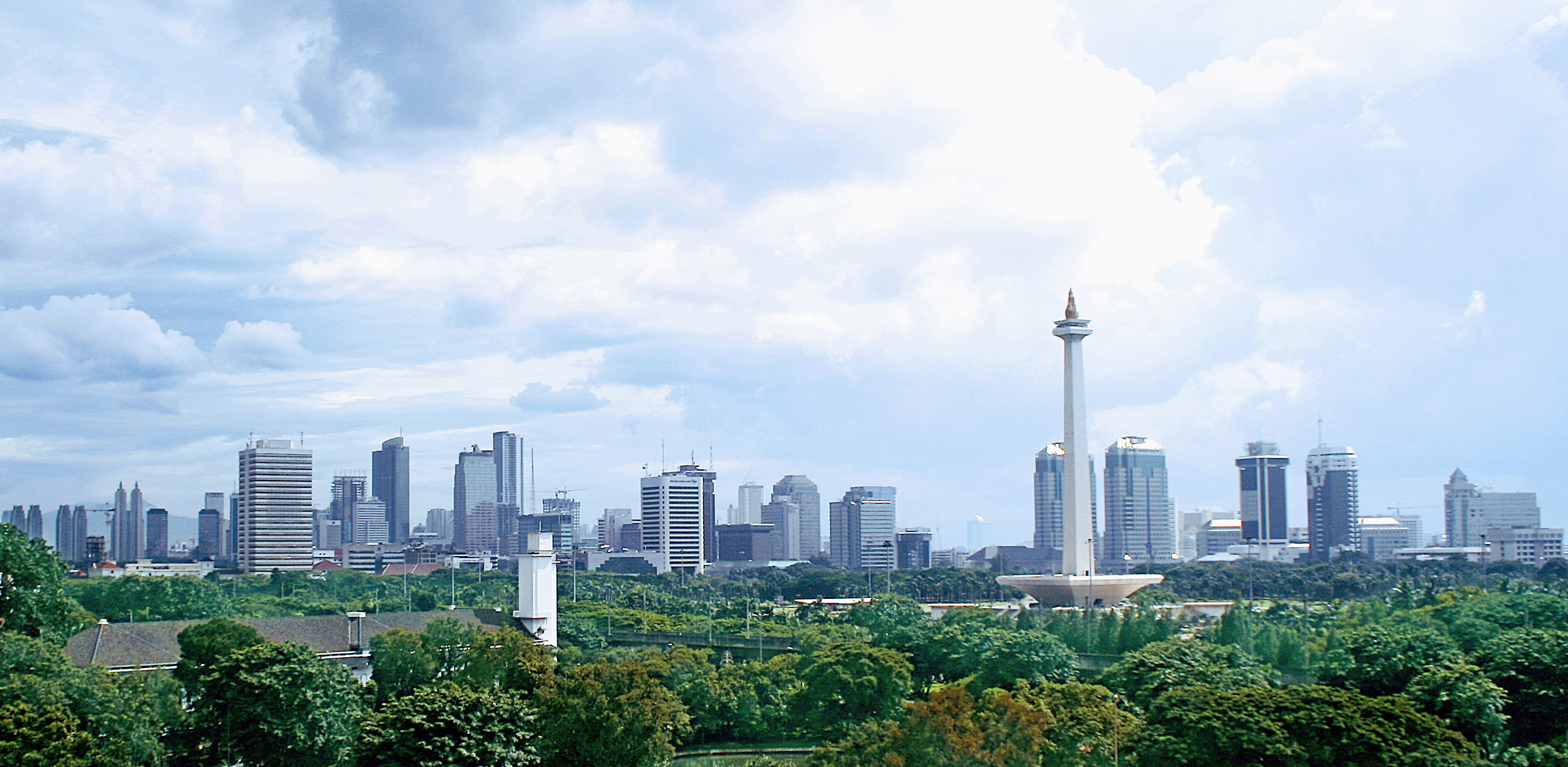 Jakarta panoramic view around Medan Merdeka (Merdeka square), the center of Jakarta and the nation. Monas (National Monument) on the foreground with rising Jakarta skylines on the background.