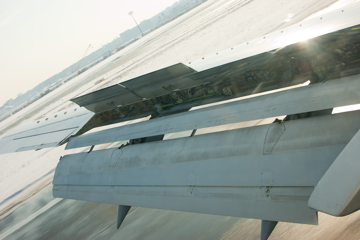 Boeing 737's port wing with flaps and spoilers extended after touchdown (landing)