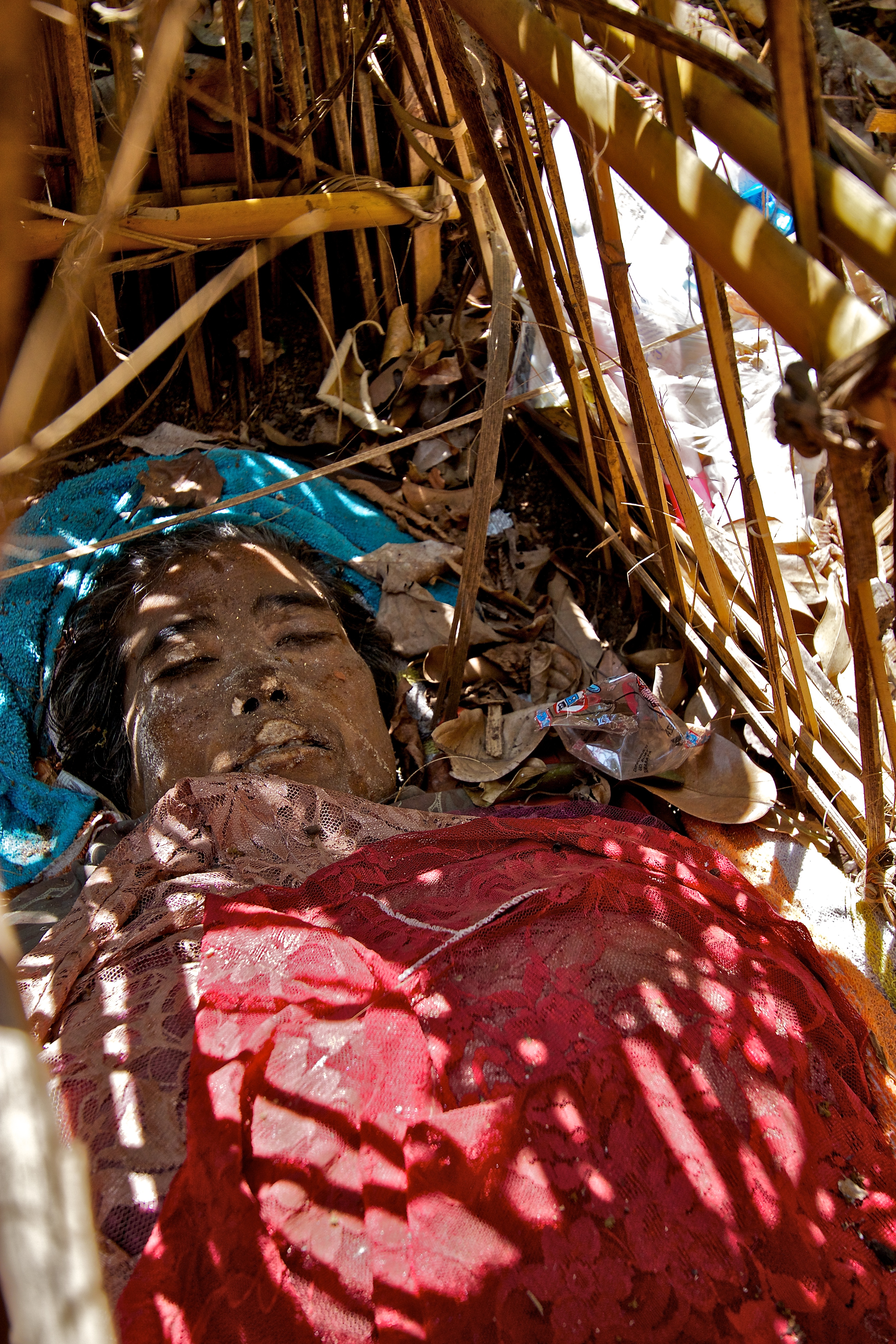 The body of a young lady, put to rest a month ago to decompose, Trunyan, Lake Batur, Bali, Indonesia