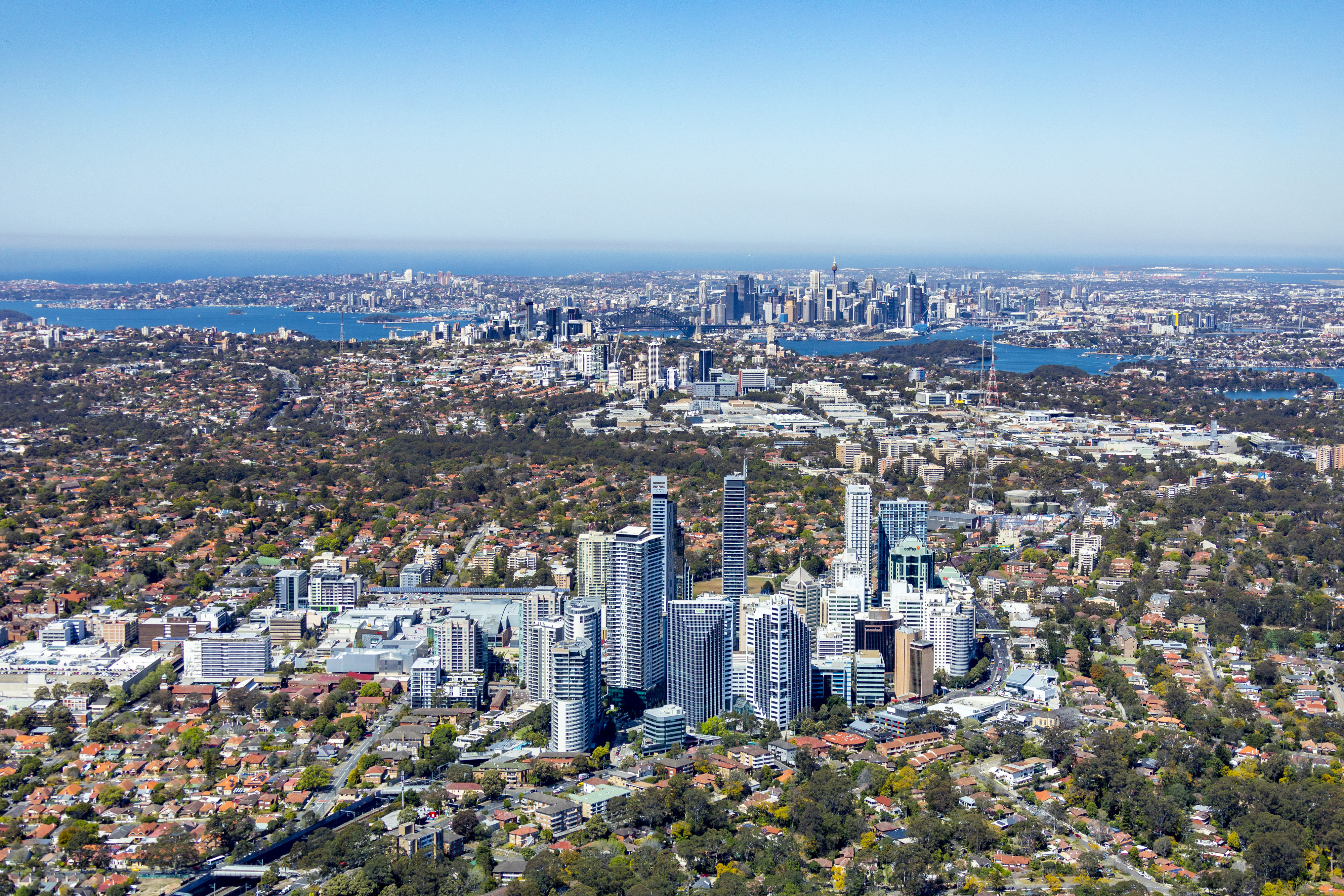An aerial image looking south over Chatswood, to St Leonards and Sydney City in the distance.