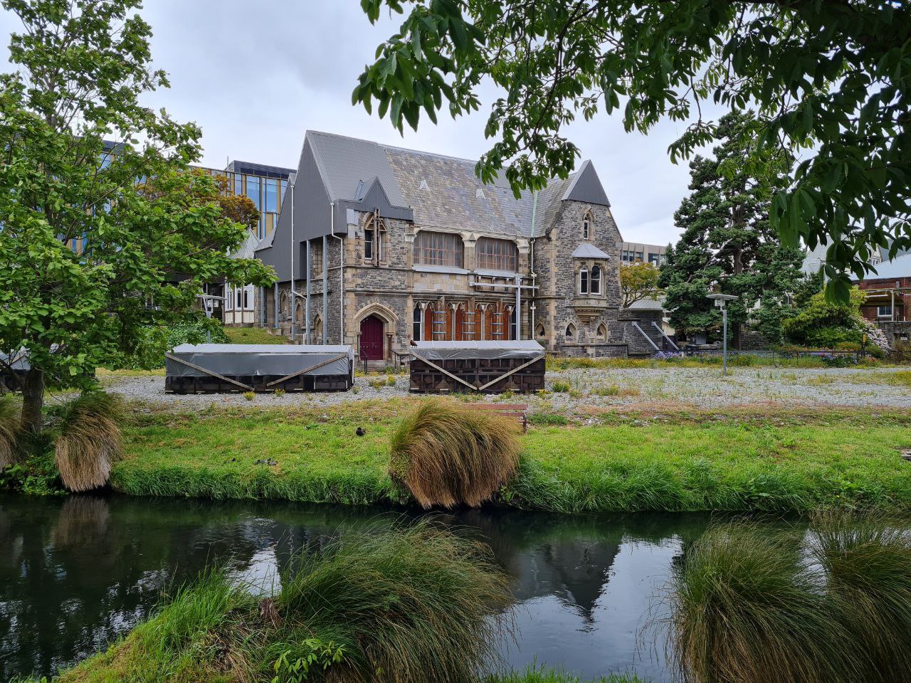 The earthquake-damaged Bellamy's building viewed across the Avon River, January 2023
