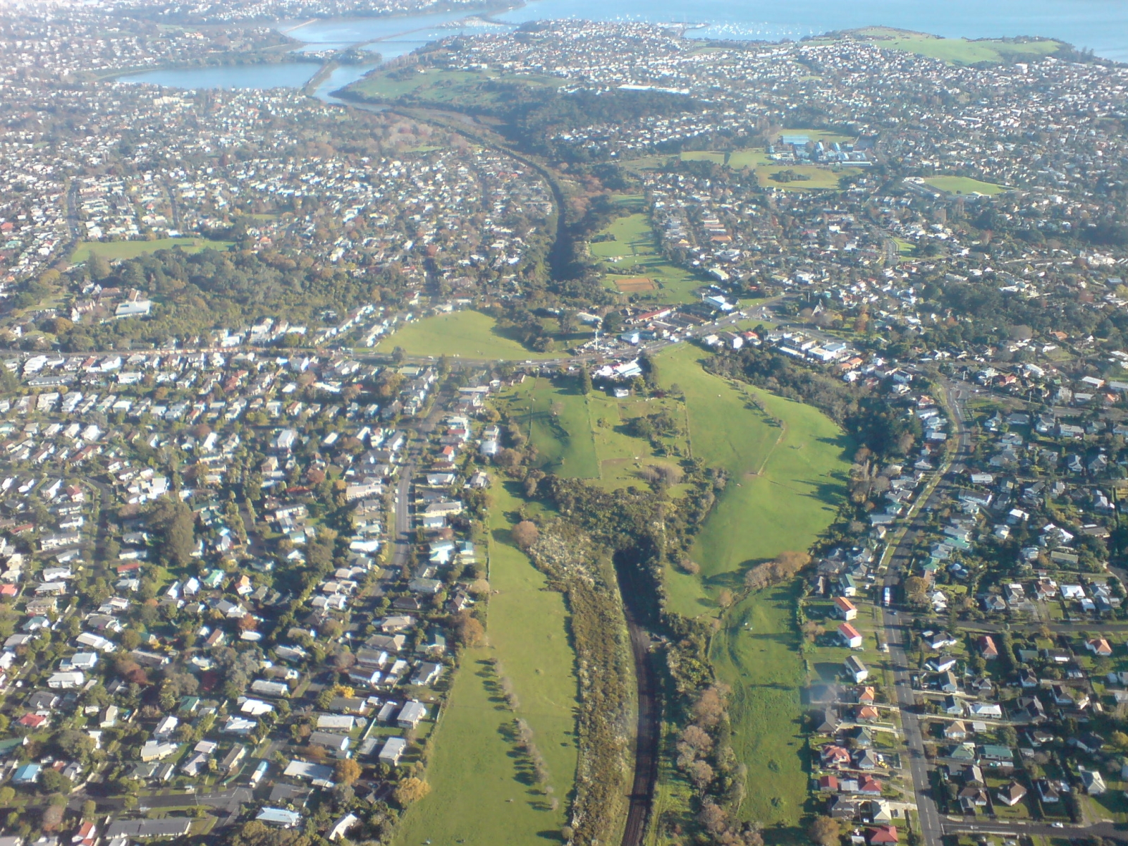 The North Island Main Trunk Railway, in the area of the Eastern Transport Corridor seen looking westwards towards the Auckland CBD, New Zealand.