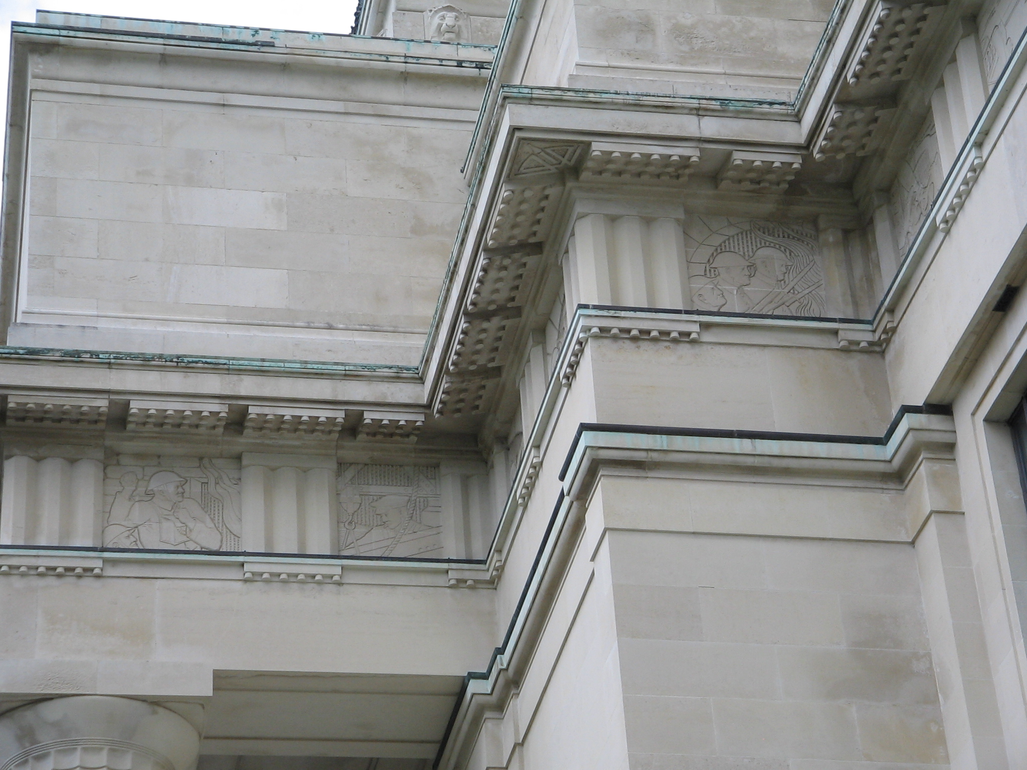 Part of the entablature on the facade of the Auckland War Memorial Museum, depicting war scenes on its frieze.
