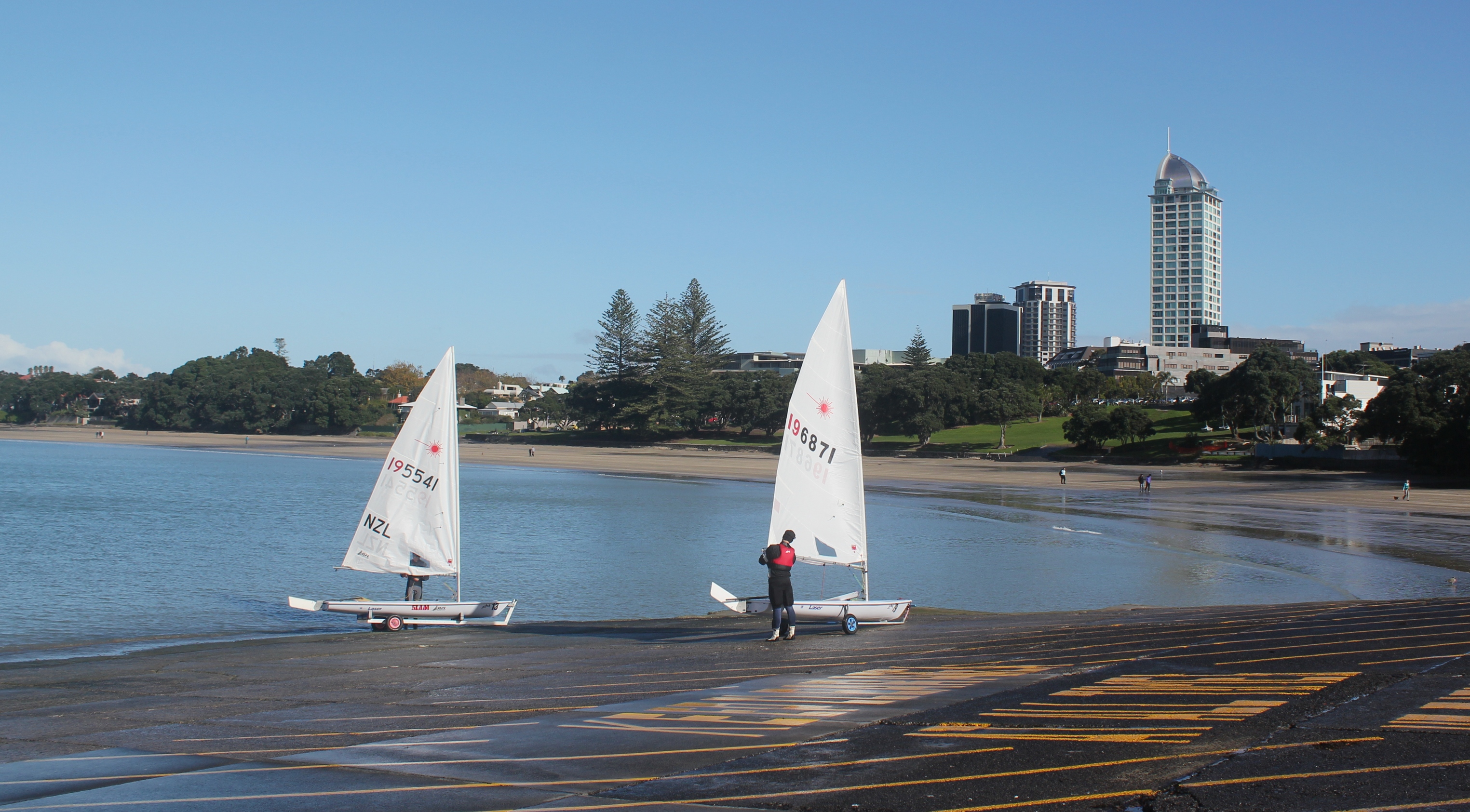 Sailors get their boats ready on the boat ramp at the north end of Takapuna beach, Auckland, New Zealand.