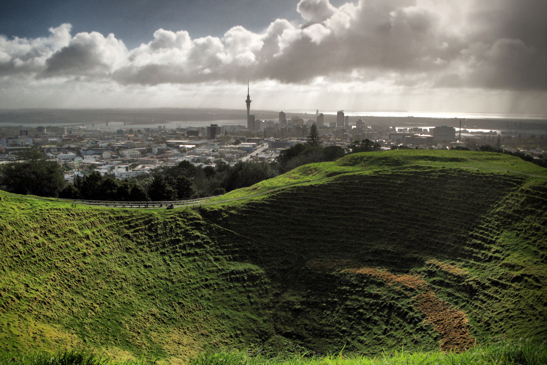 Mount Eden or Maungawhau in Auckland, New Zealand.  Photo shows the crater and downtown Auckland in the distance.