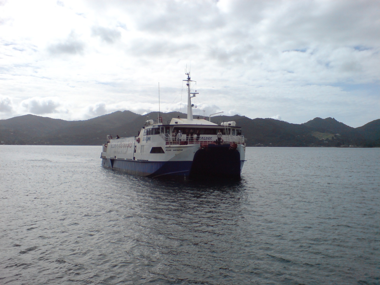 The ferry service to Great Barrier Island, New Zealand, having just arrived from Auckland at Tryphena, Great Barrier Island. The "Eco Islander" in large letters on her hull is a service name, the ship's name is Island Navigator.
IMO No: 8829323
Owner: Subritzky Shipping Company