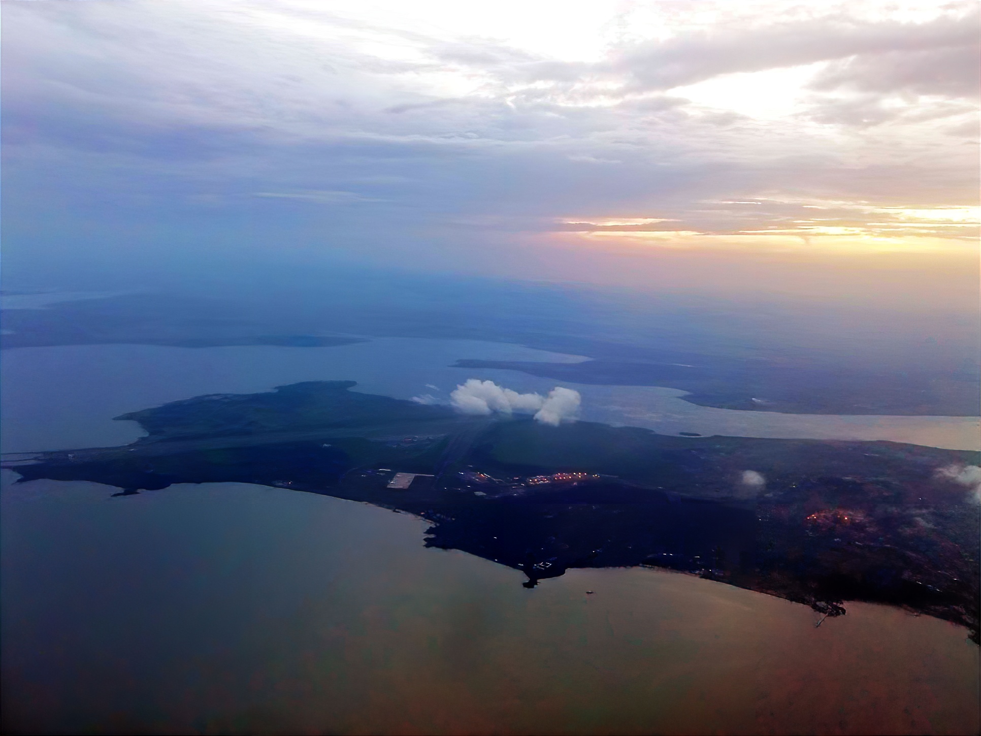 Aerial shot of the city of Entebbe and Entebbe International Airport in sunset.