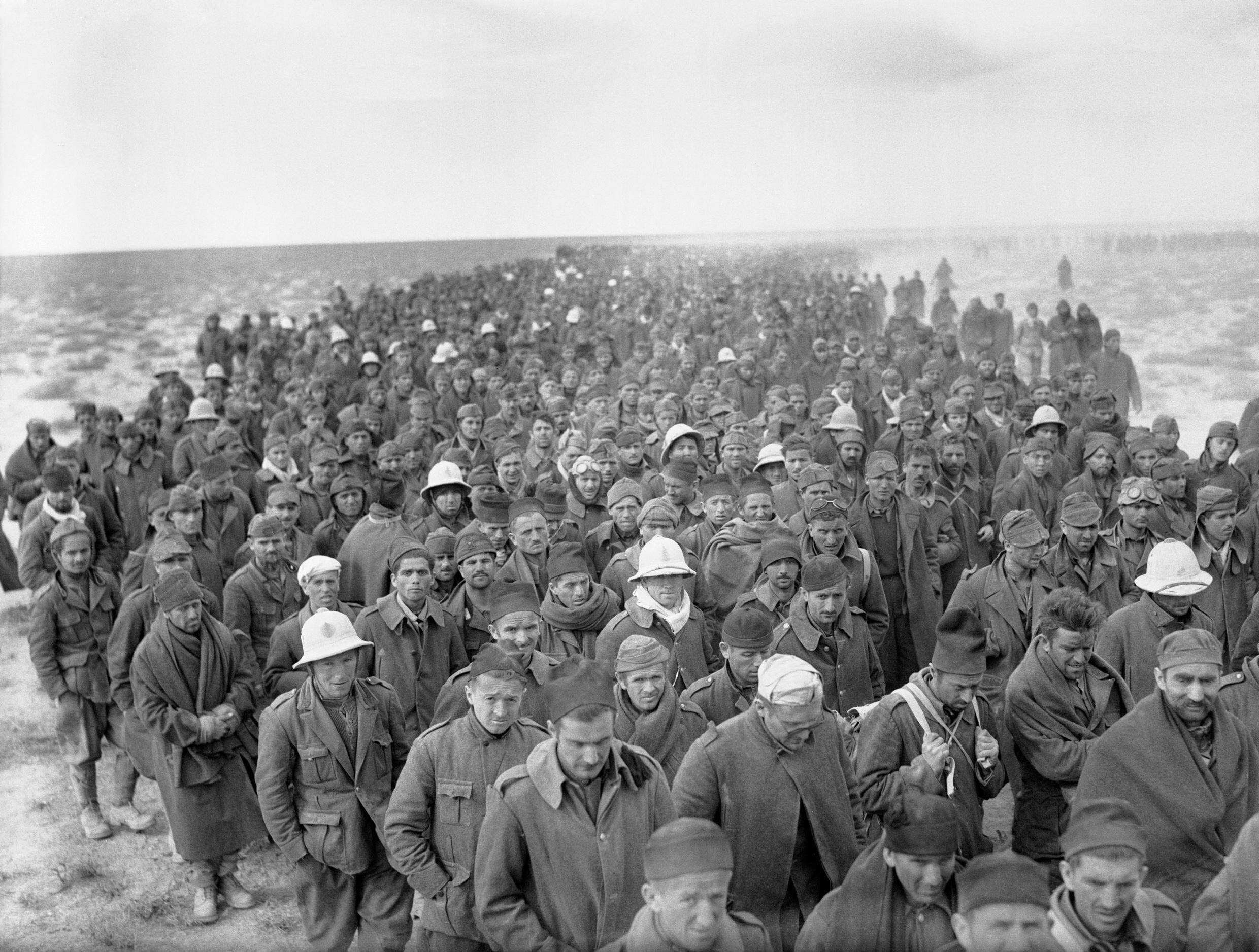 A column of Italian prisoners captured during the assault on Bardia, Libya, march to a British army base on 6 January 1941.