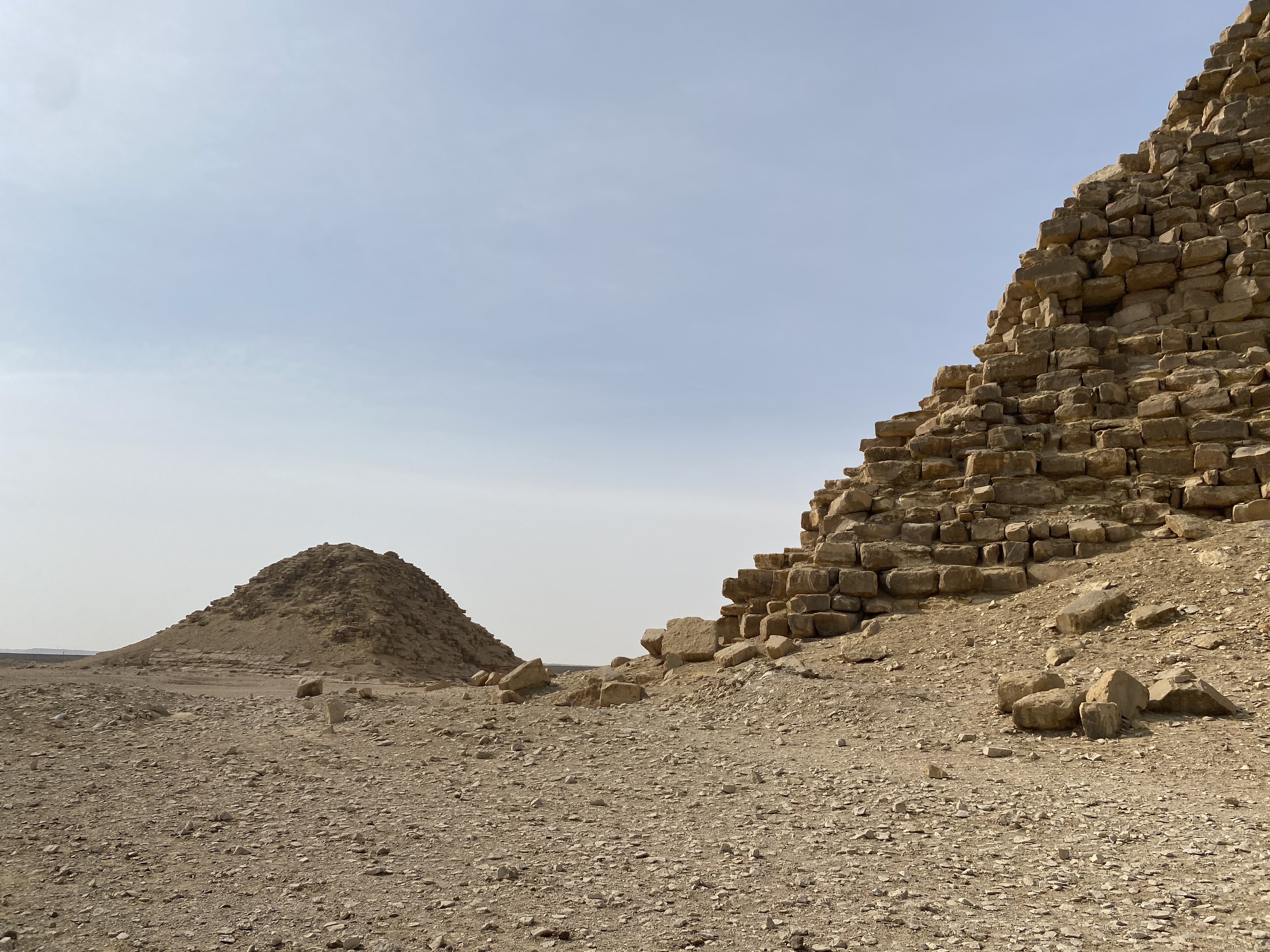 A photograph of the Bent pyramid with its Satellite pyramid photographed from the eastern side of the Bent pyramid.