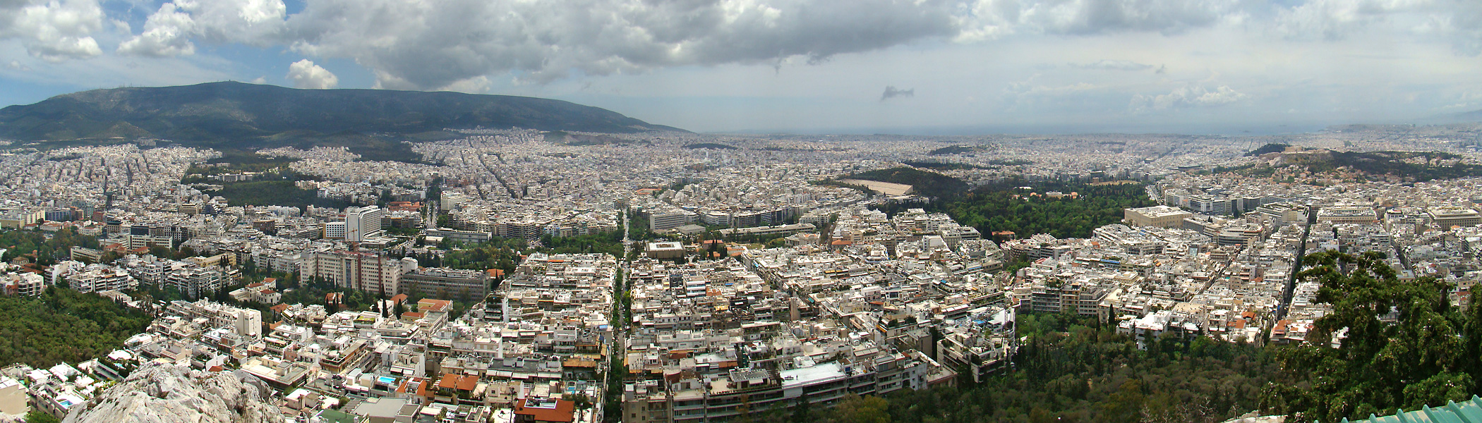 Athens, Greece. Panorama from the top of Mount Lycabettus, looking southwest. Visible sites on the right part of photo: the Panathinaiko Stadium, the Temple of Olympian Zeus, the Hellenic Parliament, the Syntagma Square, the Acropolis and the Parthenon.