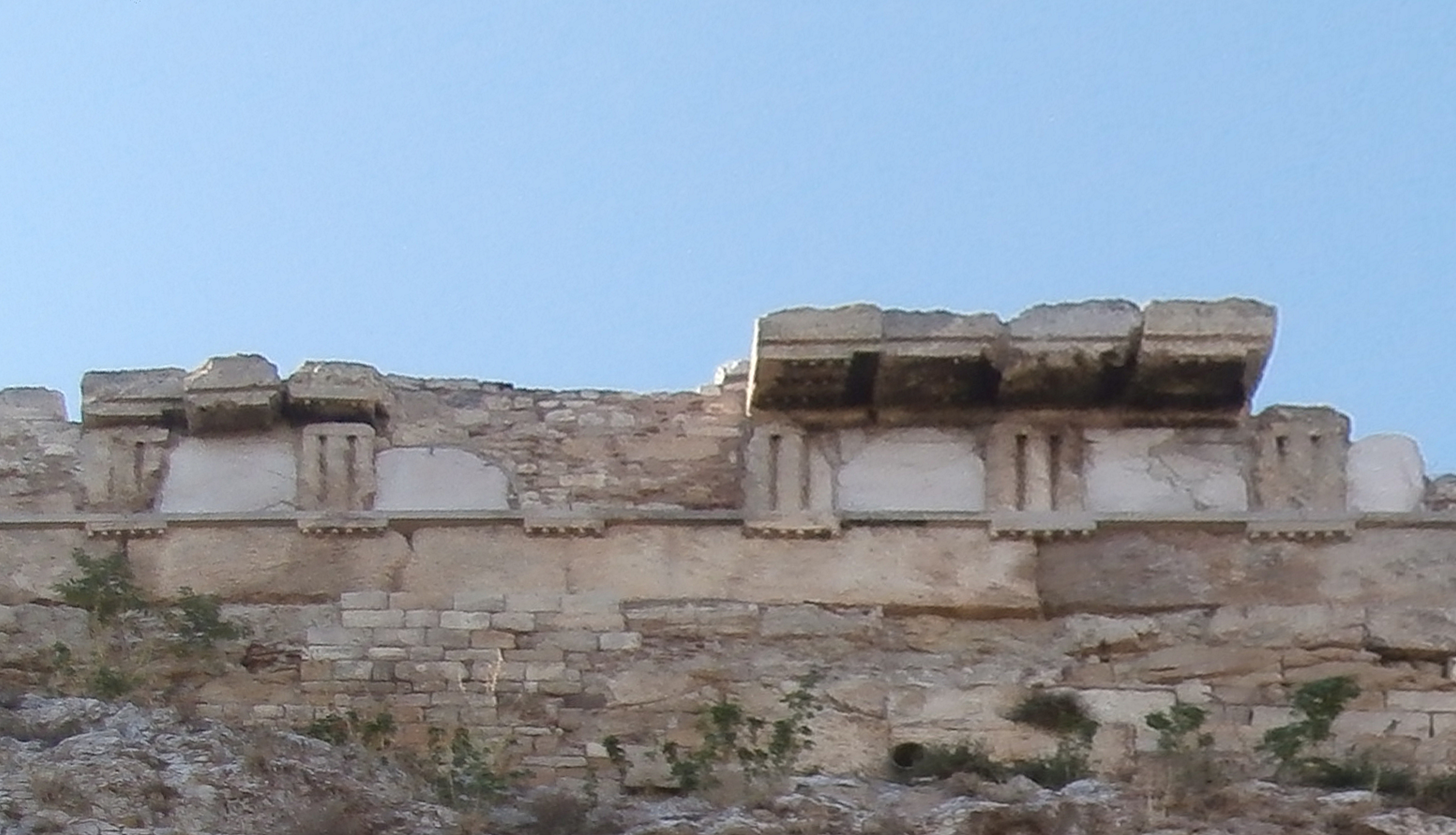 Remains of the Old Temple of Athena built into the northern wall of the Acropolis