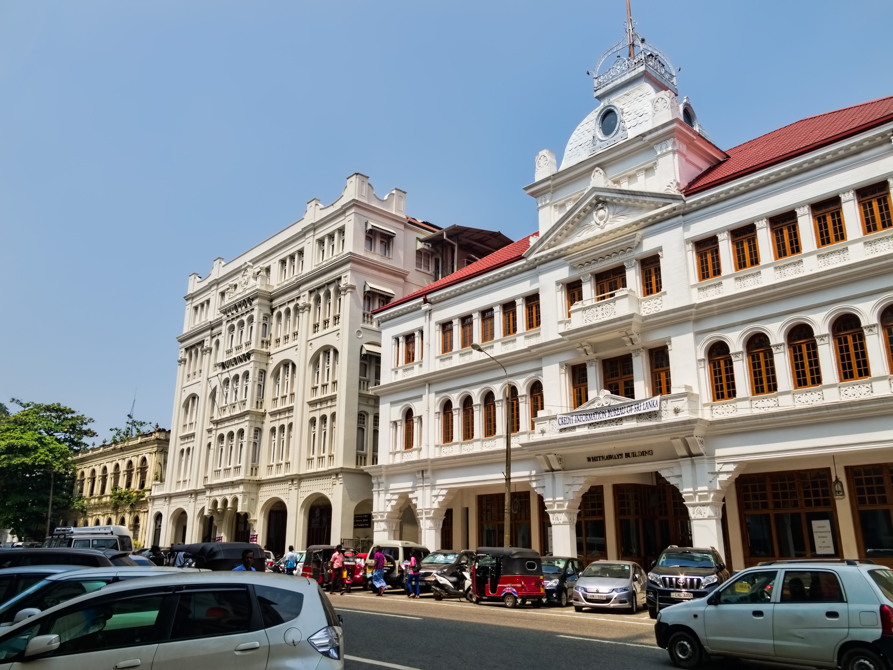 Restored colonial-era buildings in Fort. The covered, colonnaded sidewalk was typical of colonial architecture to provide protection from sun and monsoons.
Fort, where in the 1870s the British built a fort now gone, is the center of Colombo and is seeing a resurgence after the bombing of the Central Bank in 1996 during the civil war with the Tamil Tigers prompted businesses to disperse to outlying neighborhoods. The government has realized that restoring heritage buildings rather than replacing them with modern high-rises will create an area more attractive to locals and tourists alike.
On Google Earth:
Fort 6°56'10.83"N, 79°50'39.44"E