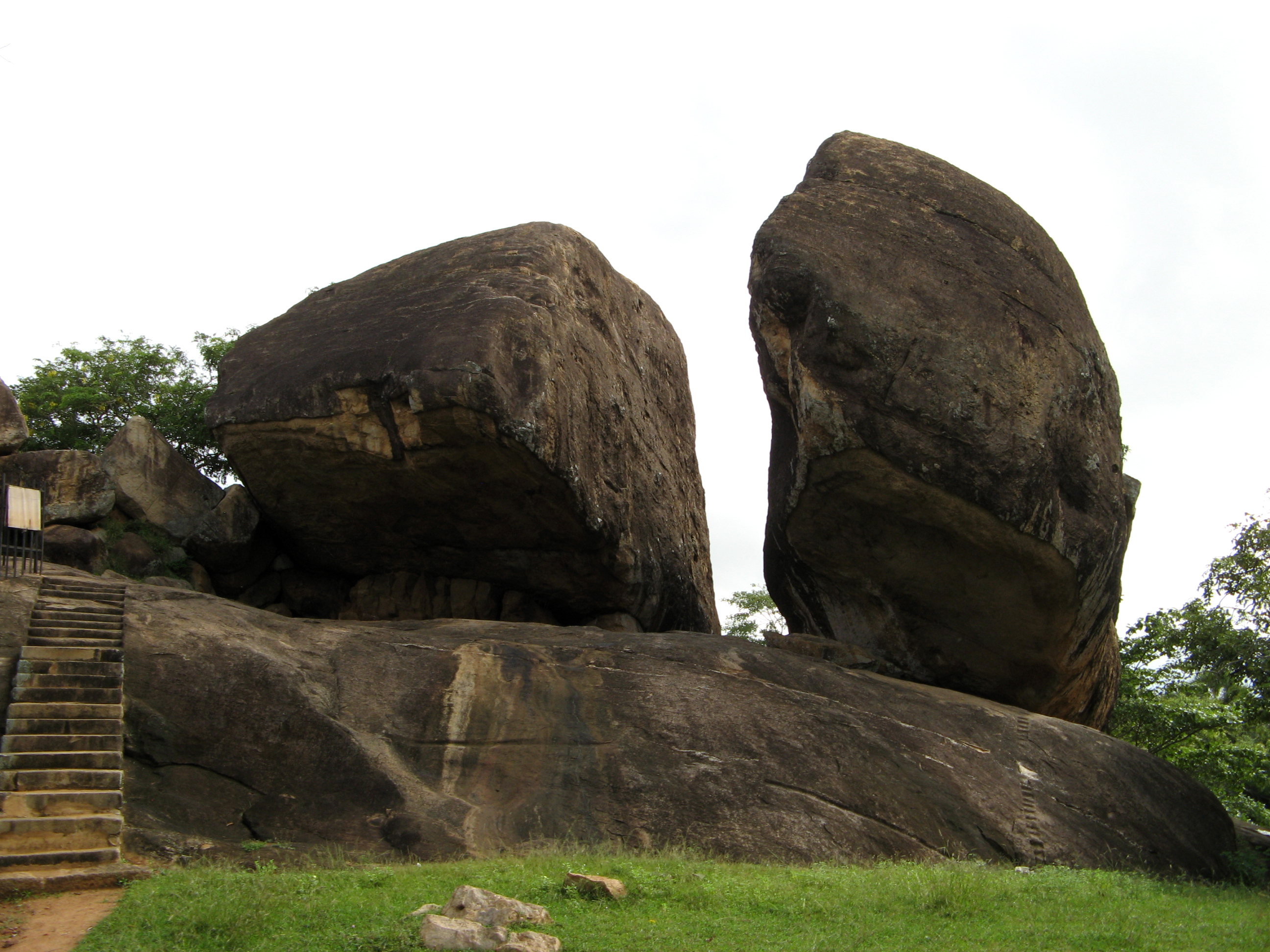 Vessagiri Forest Monastery, Anuradhapura, Sri Lanka
These rock shelters were donated to Buddhist monks to use as dwellings, starting in the reign of King Devanampiya Tissa (mid-3d century BC). The site was expanded much later, during the reign of King Kasyapa (473 - 491 AD), at which time it became home to about five hundred monks.
Today's visitor sees only the bare stones - and not all of those, since much of the rock was later carted away and reused elsewhere. But when occupied, the dwellings were finished using wood and other perishable materials.