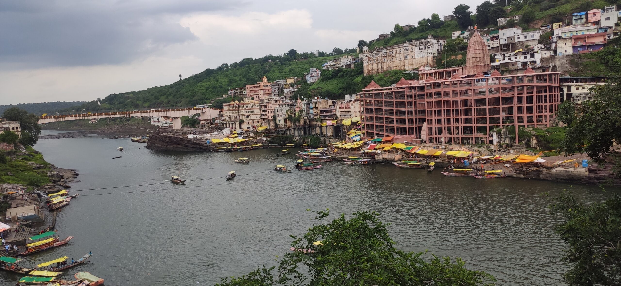 Omkareshwar Jyotirlinga temple view from Brahmeshwar Mahadev Mandir Omkareshwar. This temple is a revered Hindu pilgrimage site situated on an island in the Narmada River. The temple's unique architecture and serene surroundings attract devotees seeking spiritual solace.