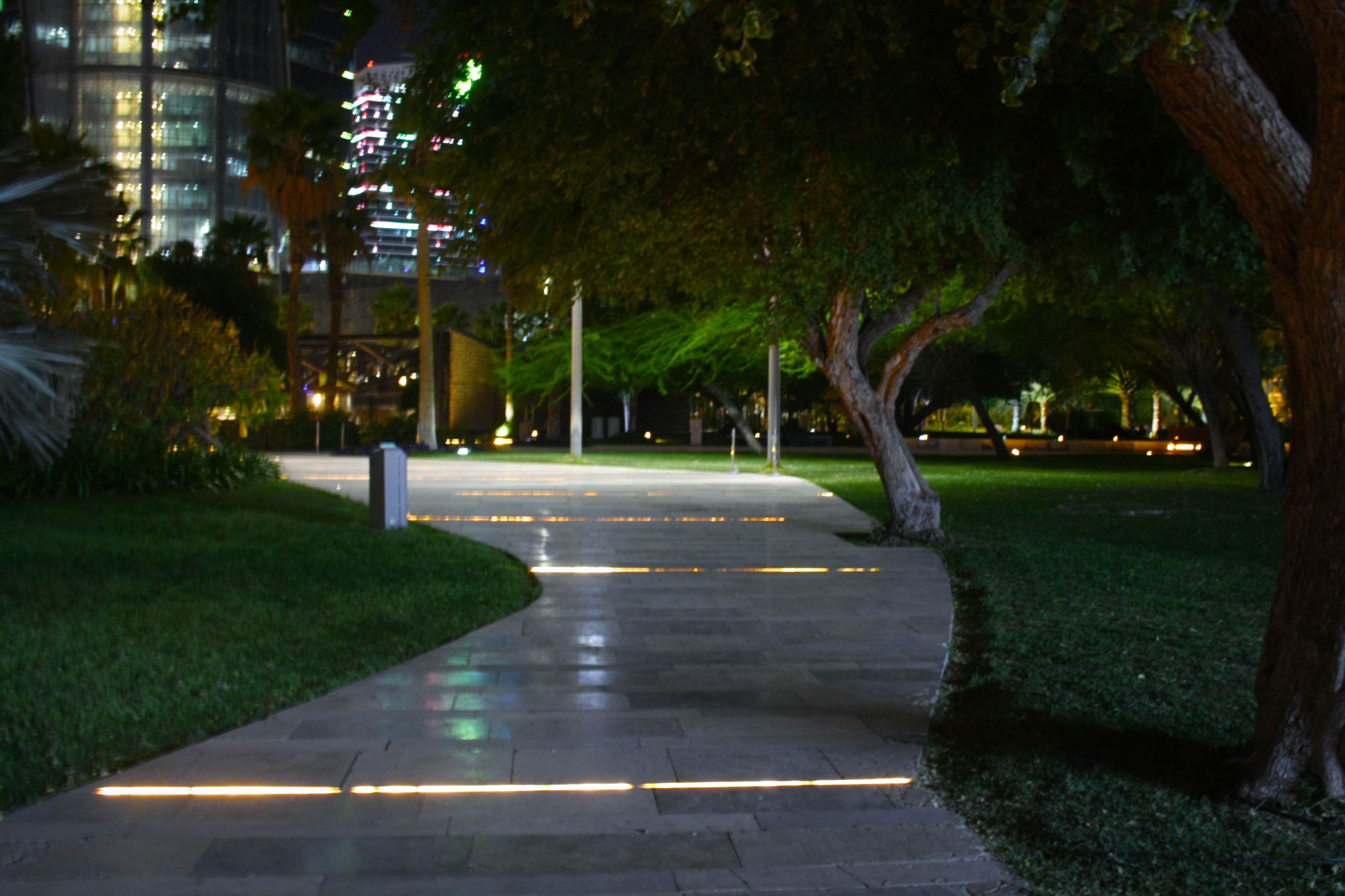 Pathway with lights and trees in Al Shaheed Park, Kuwait