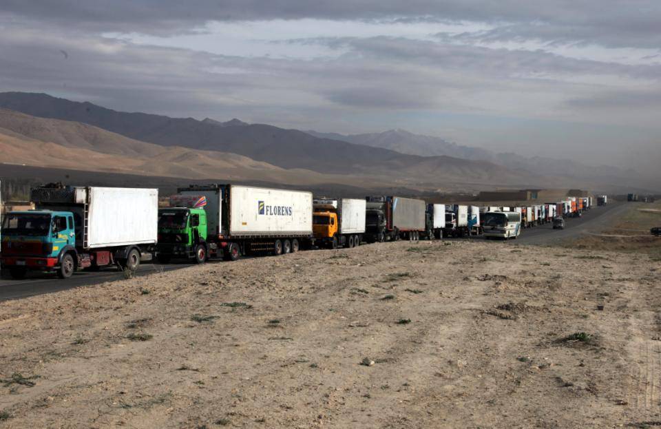 A convoy of trucks driven by Afghans wait patiently on highway 1 for elements of the U.S. military to clear the dangerous stretch of road ahead of any possible Imrovised Explosive Devices and enemy fighters in Sayed-Abad District, Wardak Province, Afghanistan, 28 March 2010. (U.S. Army photo by Sgt Russell Gilchrest\Released)