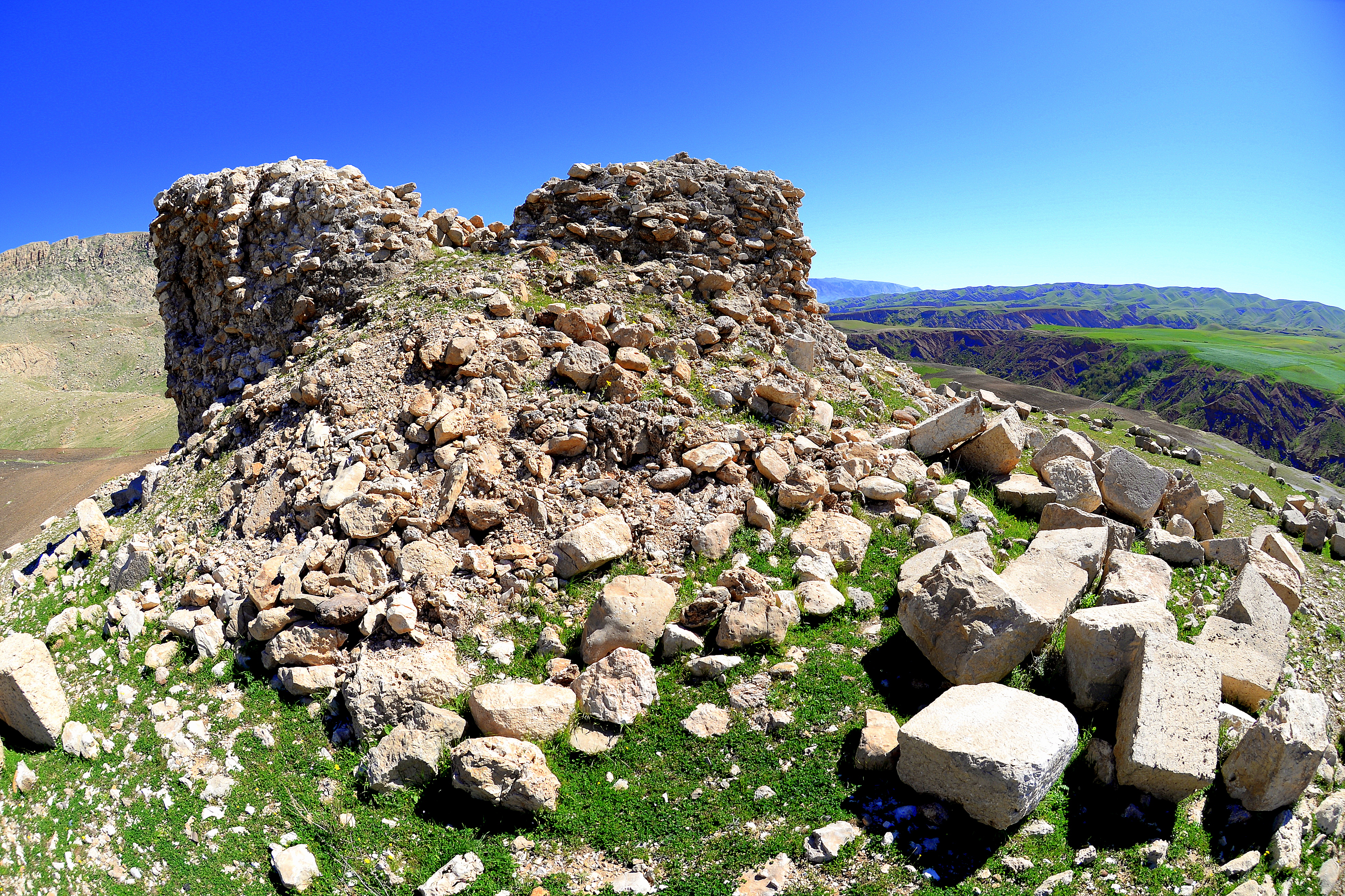 Ruins of the Paikuli tower. This is the western wall; the middle Persian version of the inscriptions was used here. The stone blocks which were used to build the tower are scattered all around the monument; these stone blocks bear no inscriptions. Nikon D610 with an AF DX Fisheye-Nikkor 10.5mm f/2.8G ED lens. March 2015.