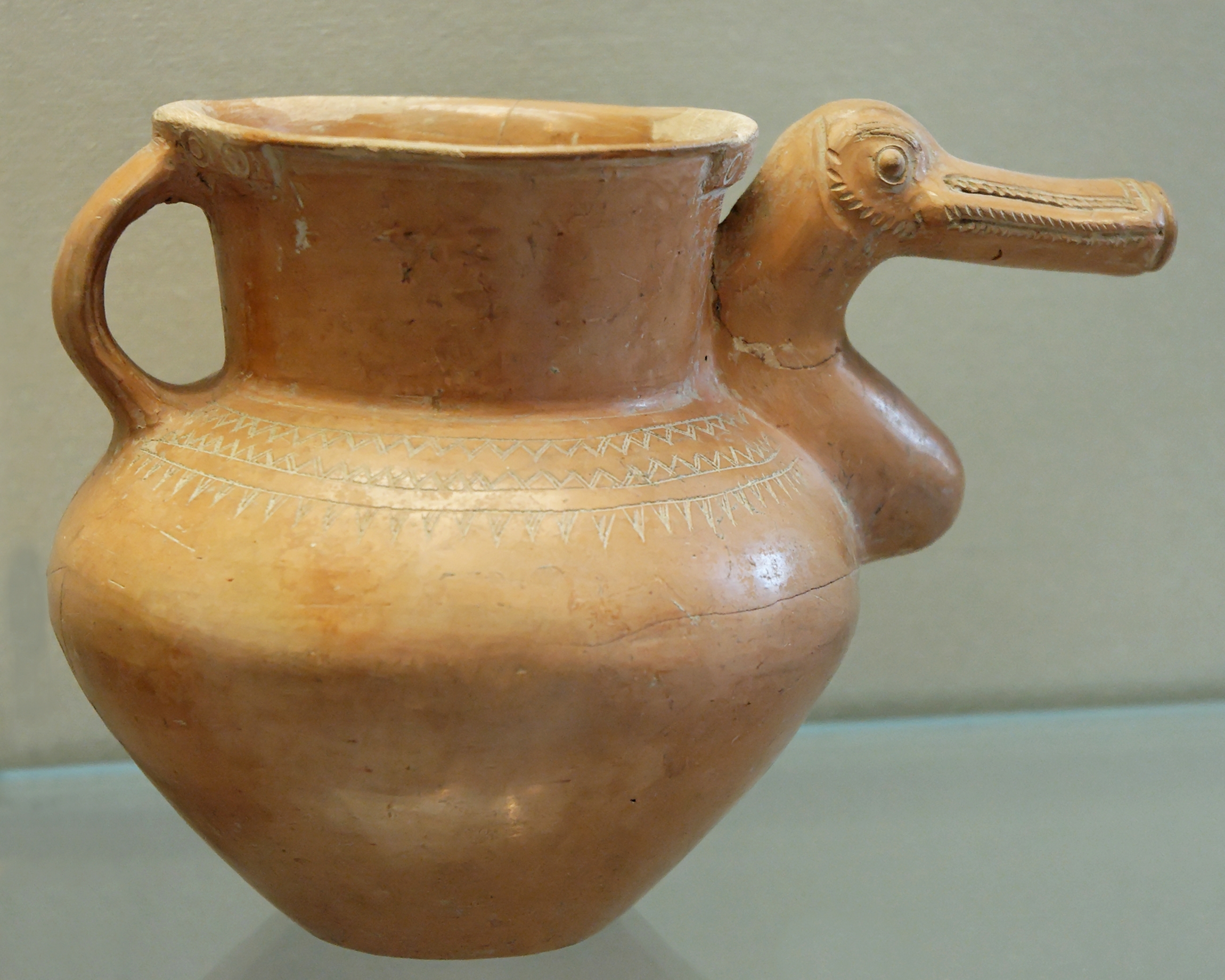 Vase with duck-shaped spout and triangle decoration on the shoulder. Lustred and incised terracotta, 8th century BC. From the Ziwiye treasure, Iran.