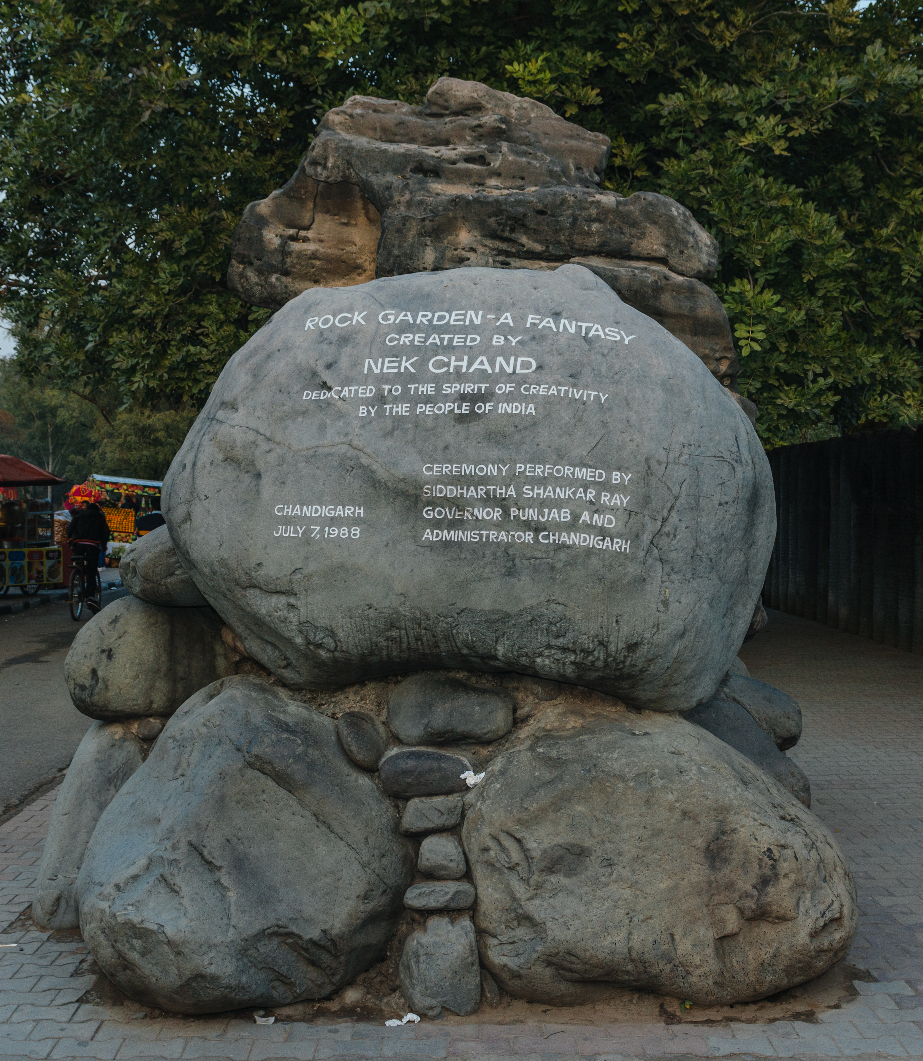 Rock Garden Memory Stone
Dedication day memorial - July 7, 1988
The Rock Garden of Chandigarh is a sculpture garden in Chandigarh, India. It is also known as Nek Chand's Rock Garden after its founder Nek Chand Saini, a government official who started the garden secretly in his spare time in 1957. Today it is spread over an area of 40 acres (161874.25 m²). It is completely built of industrial and home waste and thrown-away items.

It is near Sukhna Lake. It consists of man-made interlinked waterfalls and many other sculptures that have been made of scrap and other kinds of wastes (bottles, glasses, bangles, tiles, ceramic pots, sinks, electrical waste,brokenpipes, etc.) which are placed in walled paths.