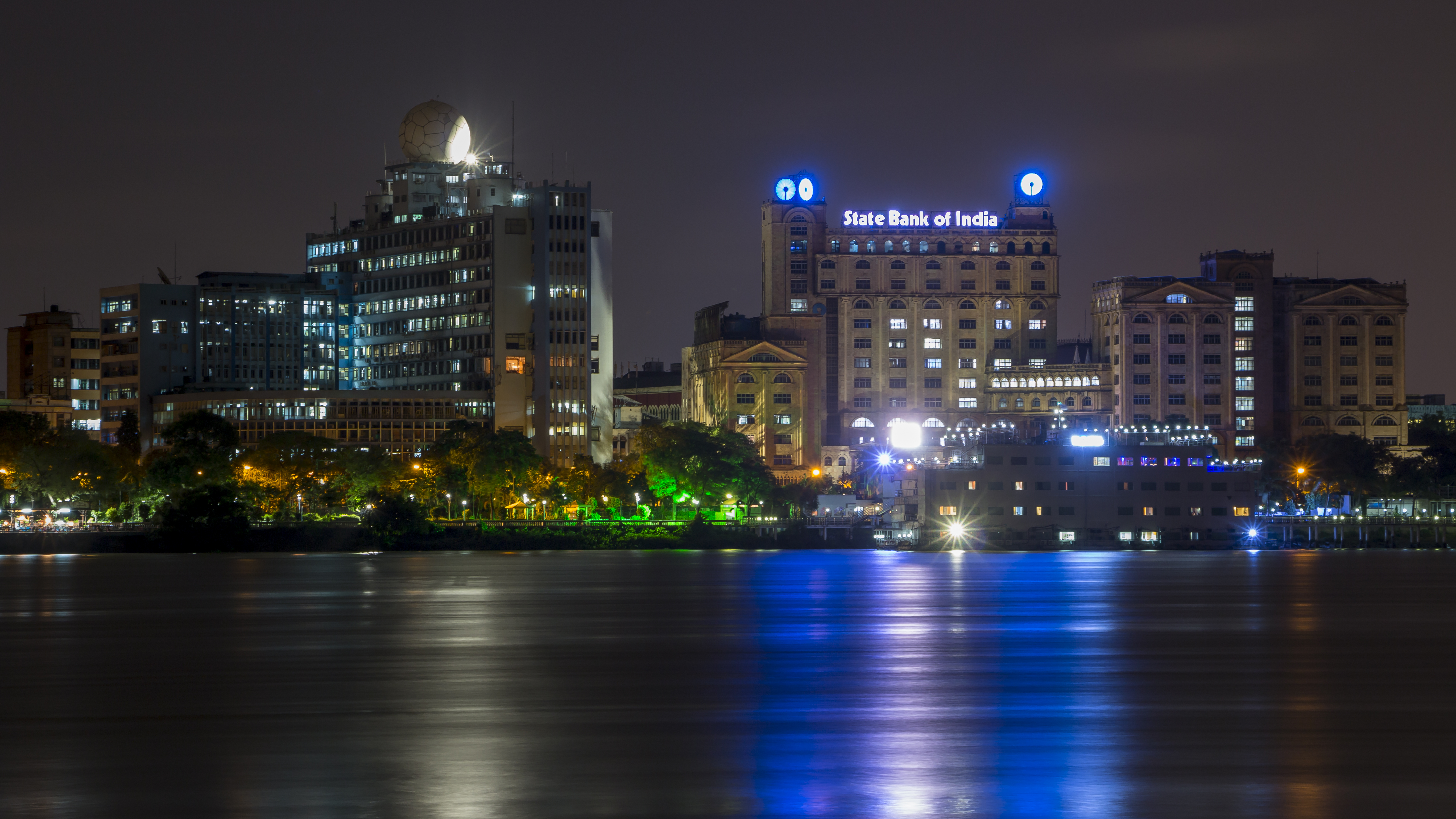 A view of the New Secretariat (left) and State Bank of India (right) buildings at night from across the Hooghly river