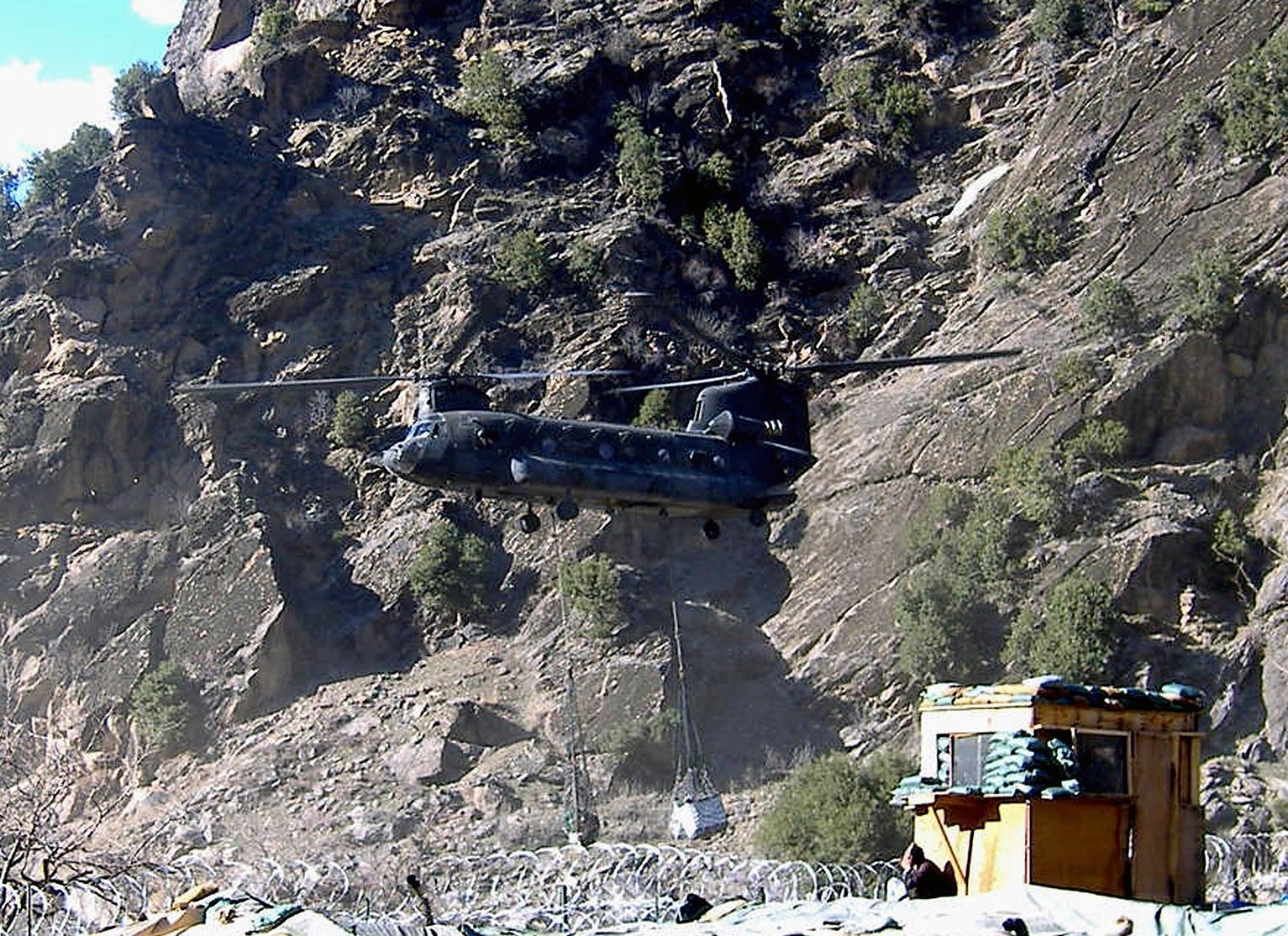 Chinook helicopter above Combat Outpost Keating, Nuristan, Afghanistan
Original caption:

" A Chinook helicopter lands at Combat Outpost Keating, Afghanistan, in this March 2007, file photo. A military investigation of a Taliban attack last fall on the remote U.S. army outpost that left eight American soldiers dead and 22 wounded has resulted in administrative punishments for two commanders blamed for "inadequate measures taken by the chain of command."
(Sgt. Amber Robinson/U.S. Army)
