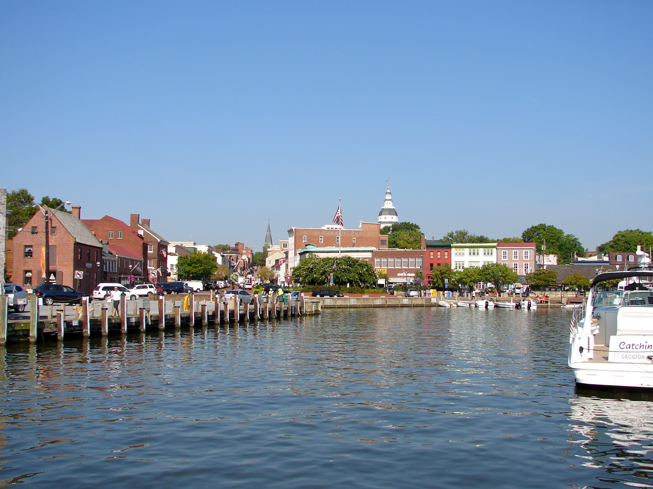The dock or harbor in Annapolis, Maryland.  Dock Street is just out of the frame of the photo to the right.  Folks leaving their boats tied up here would step right out into the street.  The Maryland State Capitol is the tall tower in the distance.  At the end of the street/harbor is a set of statues showing Alex Haley (author) reading to children.  His ancestor Kunte Kinte landed in the harbor as a slave coming from Africa, according to Haley (and historical markers near the statues).