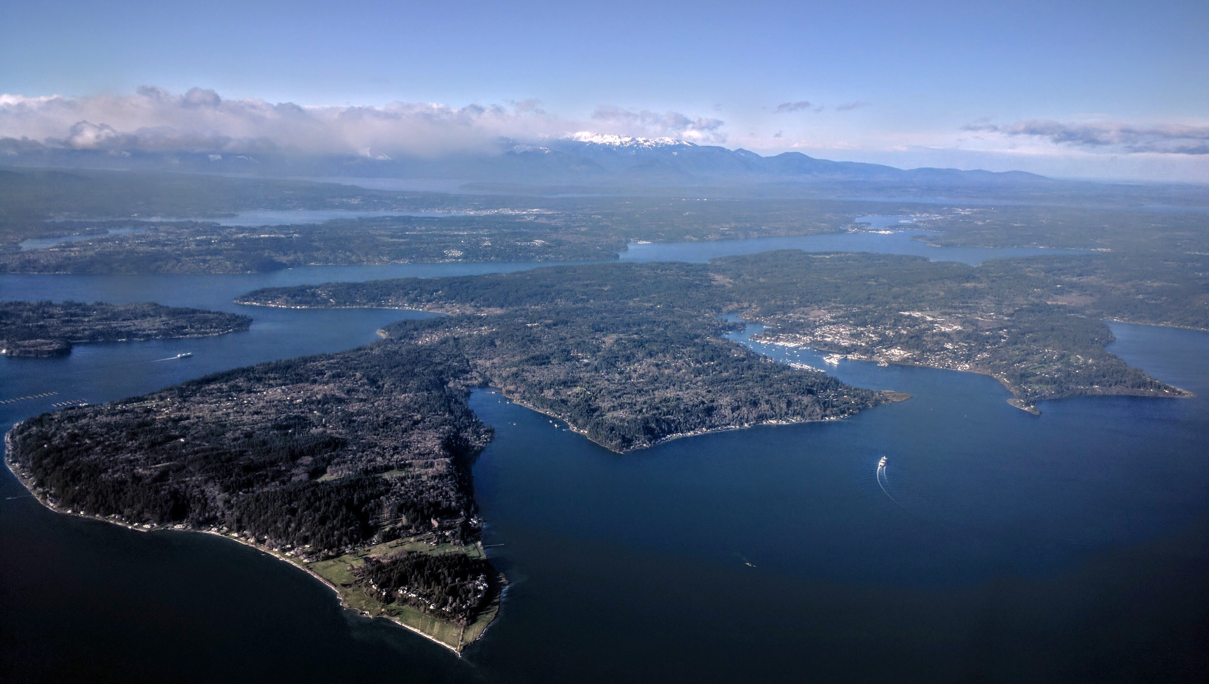 Aerial view of Bainbridge Island from the southeast, showing the Bainbridge Island ferry making the first of two turns to bring it into Eagle Harbor