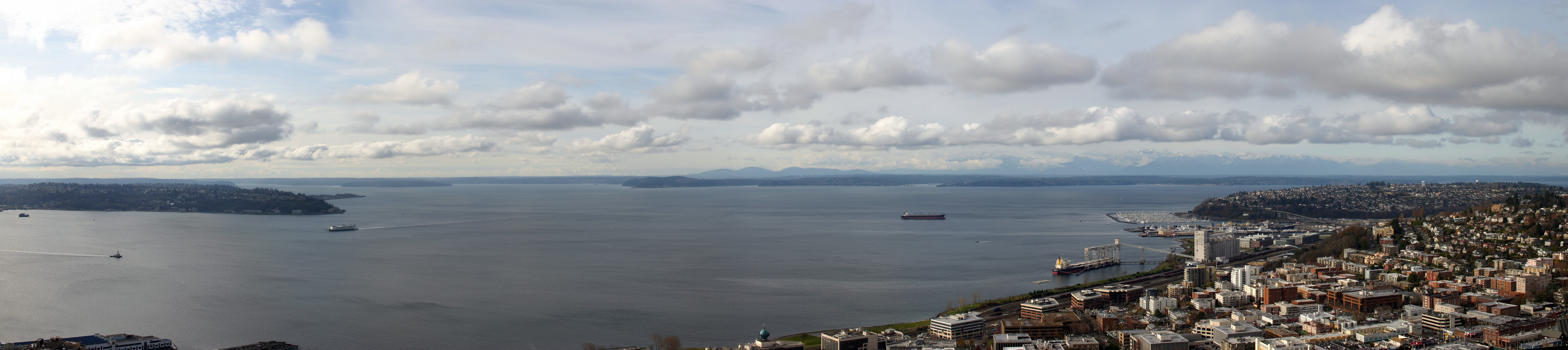 View of Puget Sound from the Seattle Space Needle. On the horizon, Gold Mountain in Kitsap County is near center of image, w:Olympic Mountains to the right.