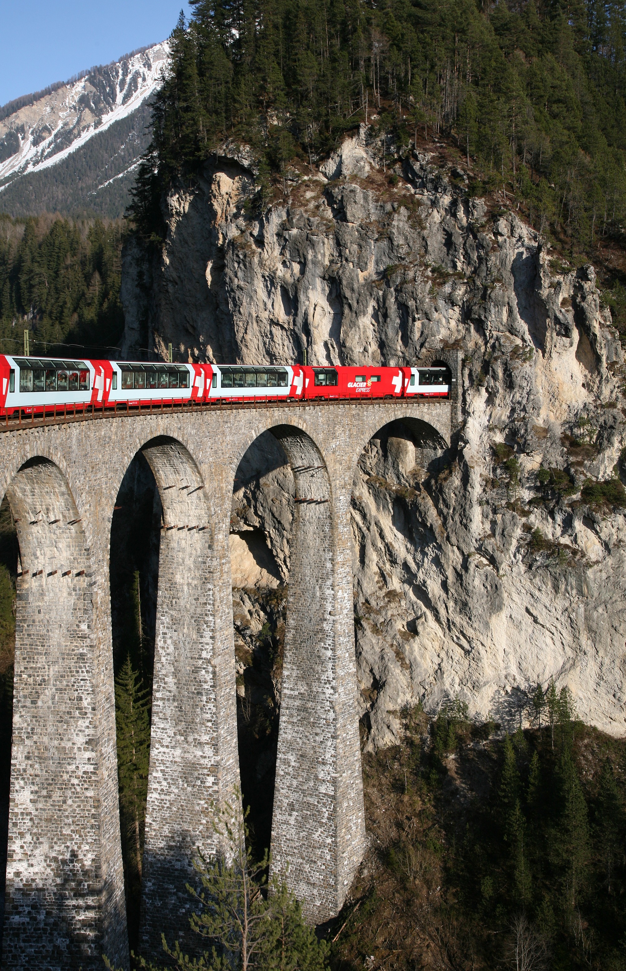 Rhaetian Railway Glacier Express on the Landwasser Viaduct entering the Landwasser tunnel