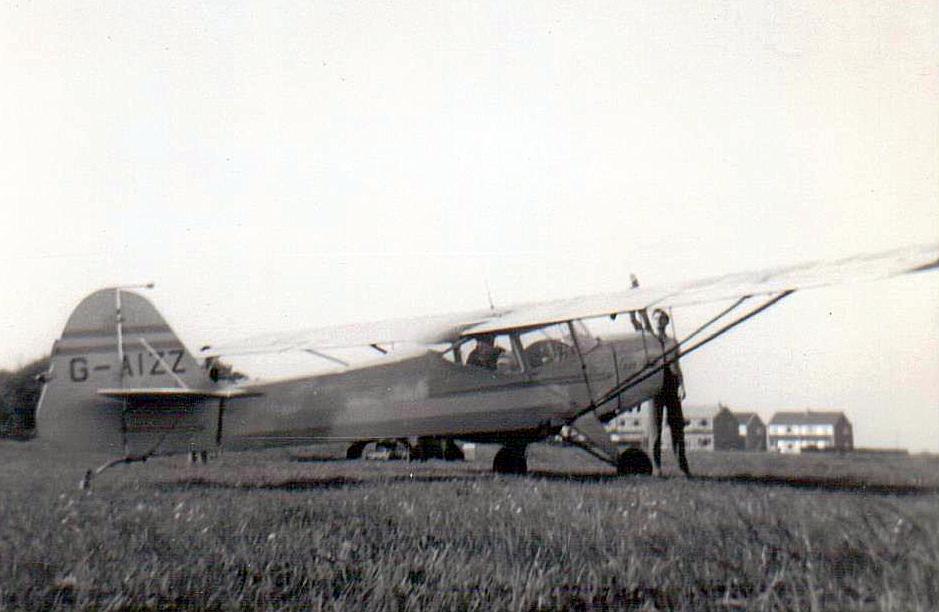 Auster 5/J1 G-AIZZ at Ramsgate Airport. The person at the front is swinging the propeller to start the engine.