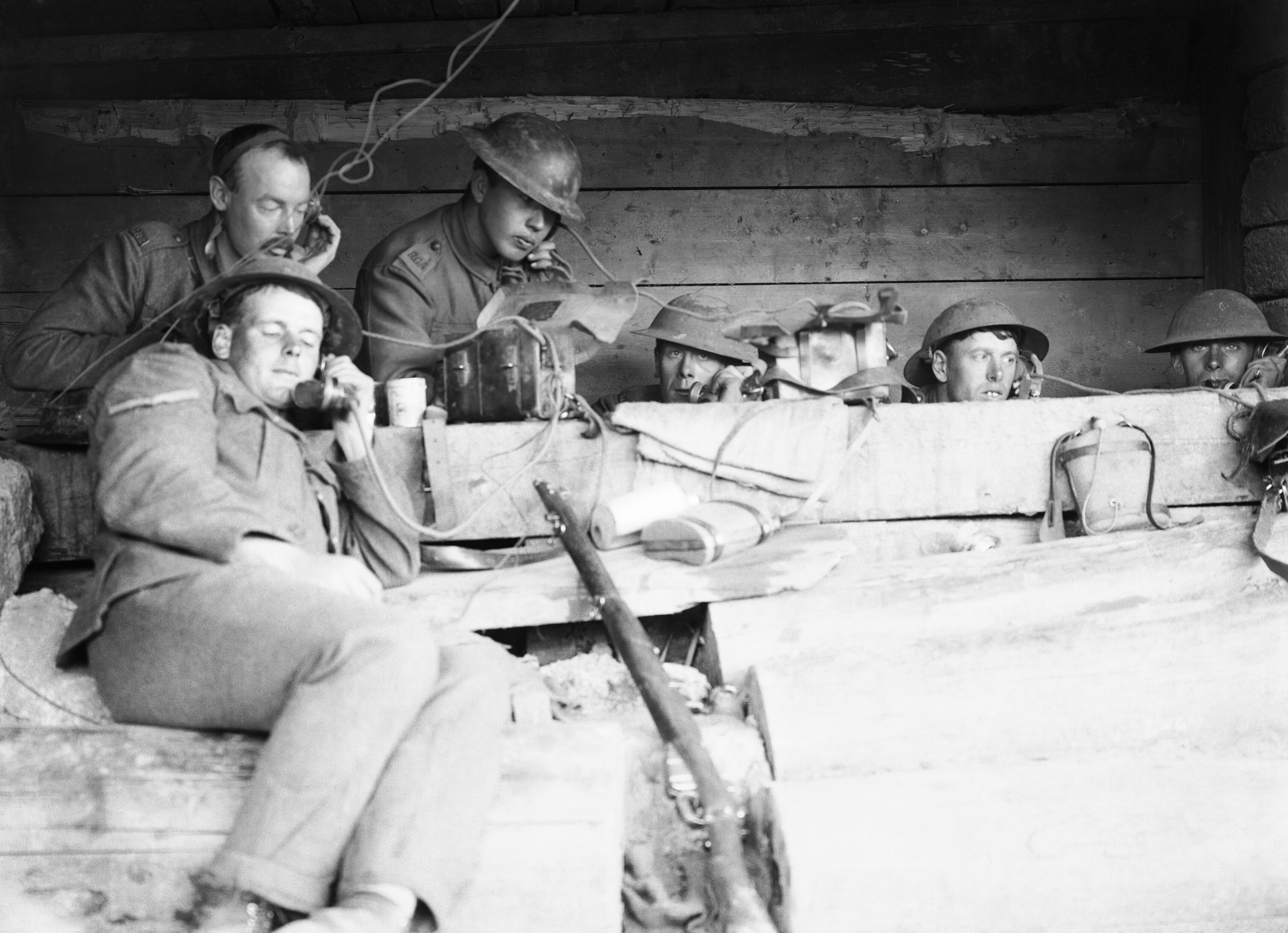 Battle of Langemarck 16-18 August 1917 : Royal Garrison Artillery telephonists at work passing messages from the forward observation officers to their batteries in a dug-out close to the front line near Langemarck, Belgium.