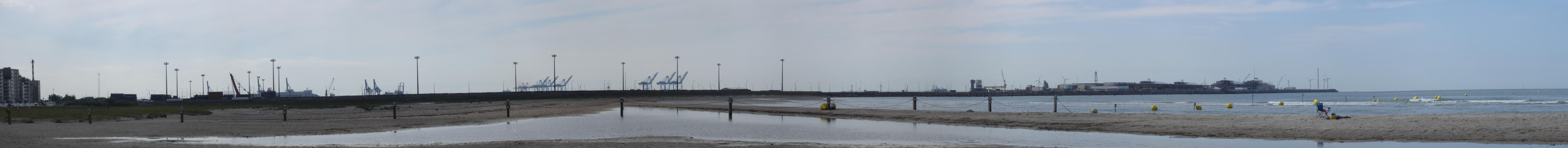 View on the eastern dam of the Port of Zeebrugge, Brugge, seen from the beach of Heist, Knokke-Heist, West-Flanders, Belgium.