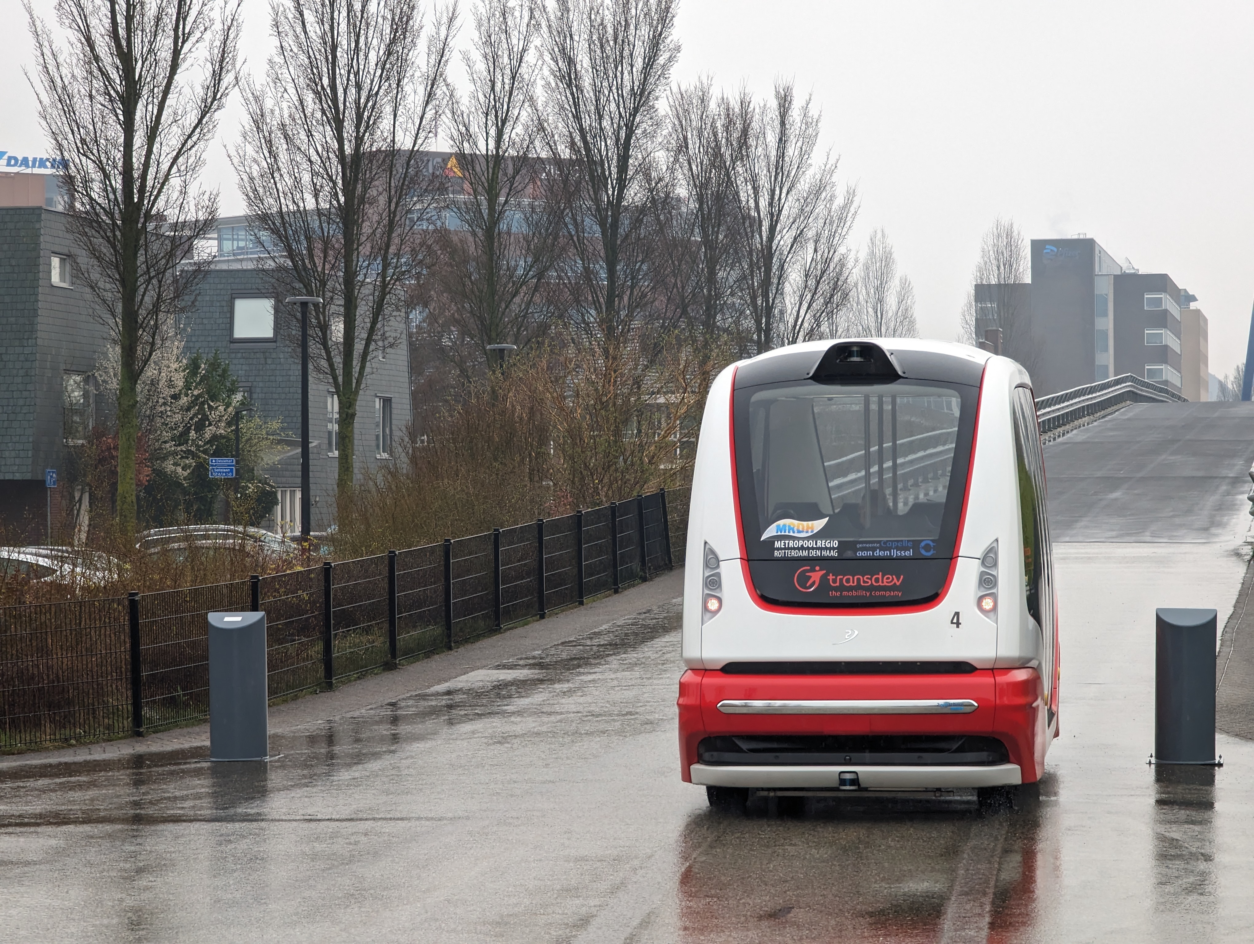Autonomous ParkShuttle vehicle (unit 4) operated by Transdev on the Rivium route in Capelle aan den IJssel, the Netherlands, on a rainy day.