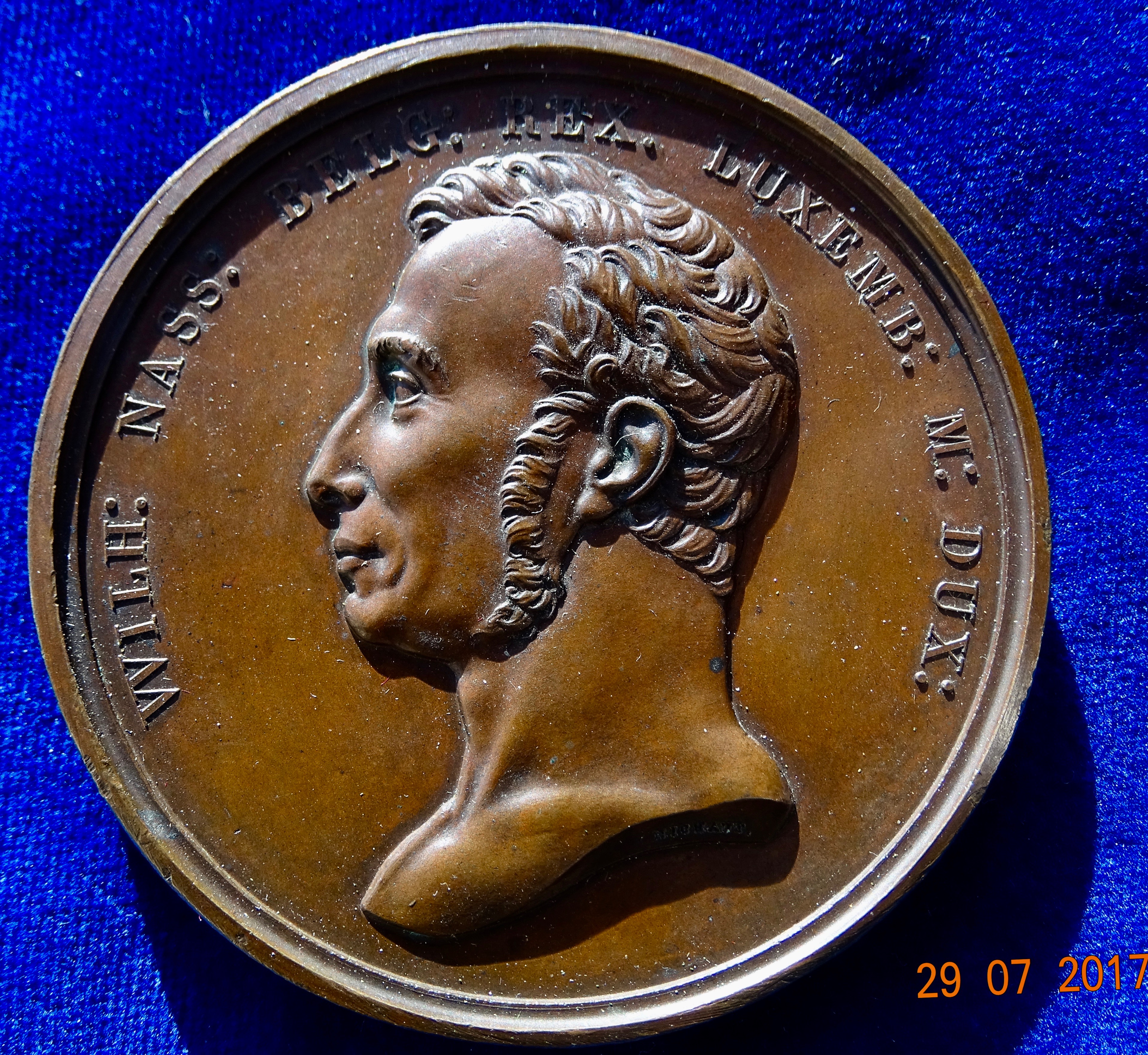 The Netherlands &amp; Belgium 1815 Unification Medal of William I, Prince of Orange-Nassau.
William I (Willem Frederik, Prince of Orange-Nassau), King of the Netherlands and Grand Duke of Luxembourg, 1815-1840

Head l., around:  "WILH: NASS: BELG: REX. LUXEMB: M: DUX:"/ Fama Belgica l. and fama Hollandia r. holding hands above 2 arms conjoined by a crown. 2 lines below: "* POSTRID. ID. MART. CICIC CCCXV.", around: "* PARIBUS SE LEGIBUS AMBAE INVICTAE GENTES AETERNA IN FOEDERA MITTUNT *". Wurzbach 9751; Forrer IV , p. 64.

Condition:   Almost UNCIRCULATED.