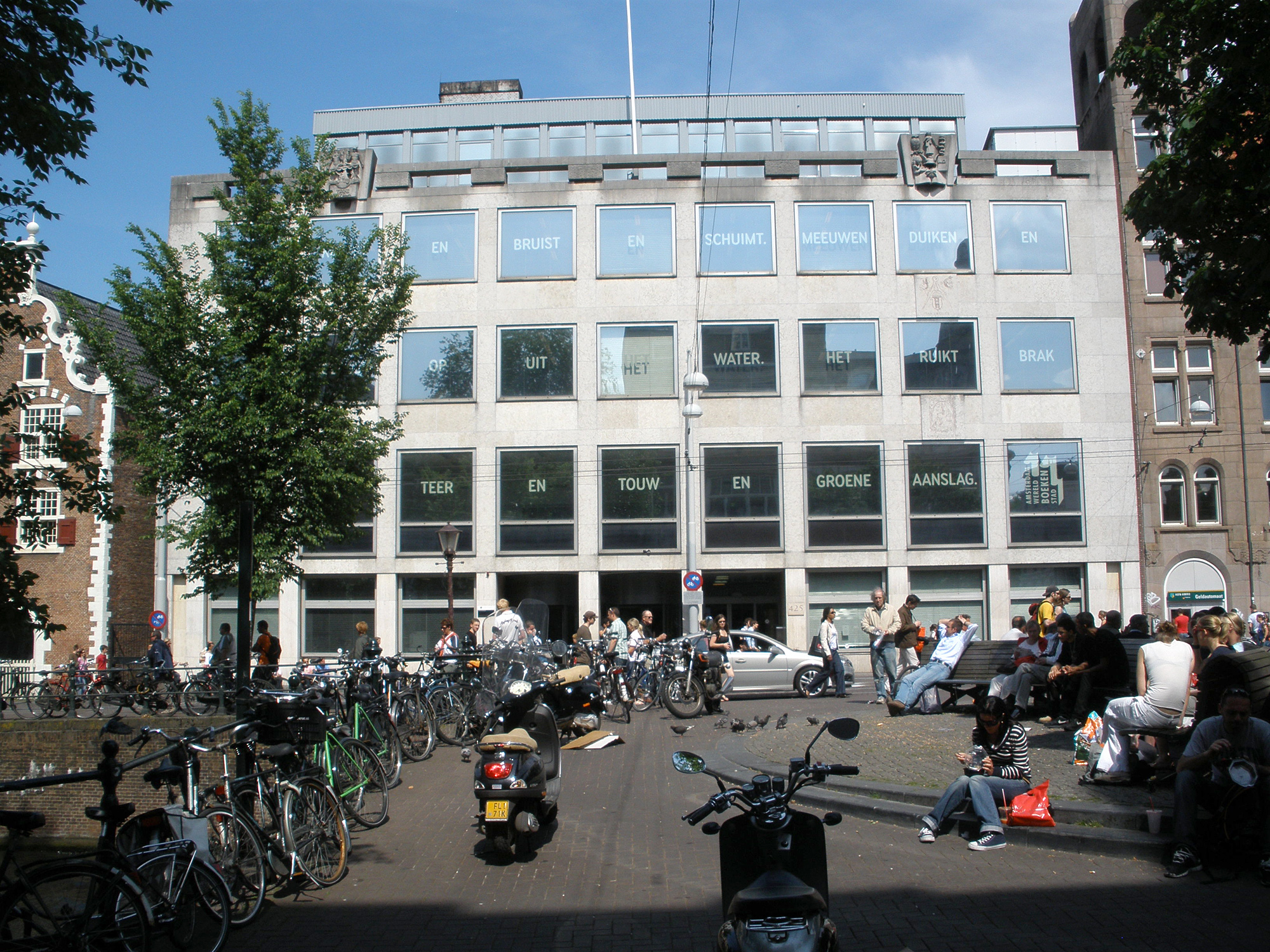 The main building of the University of Amsterdam library on the Singel canal in the centre of Amsterdam. In the front of the picture is Koningsplein square. On the left, part of the Stads-Bushuis (the former city arsenal) can be seen.