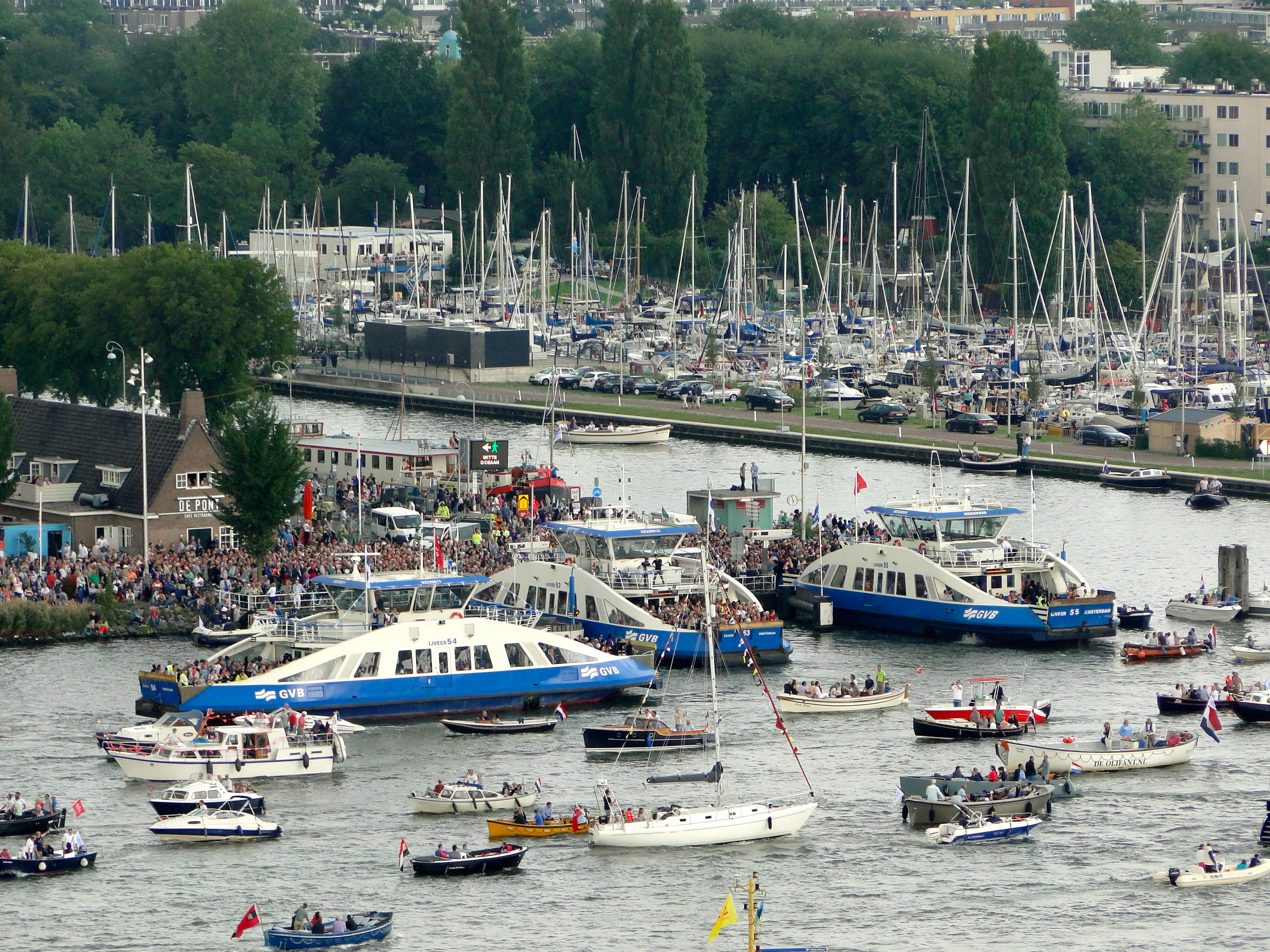 Busy Ferry Service during Sail 2015 at Buiksloterweg opposite to Centraal Station in Amsterdam on river IJ