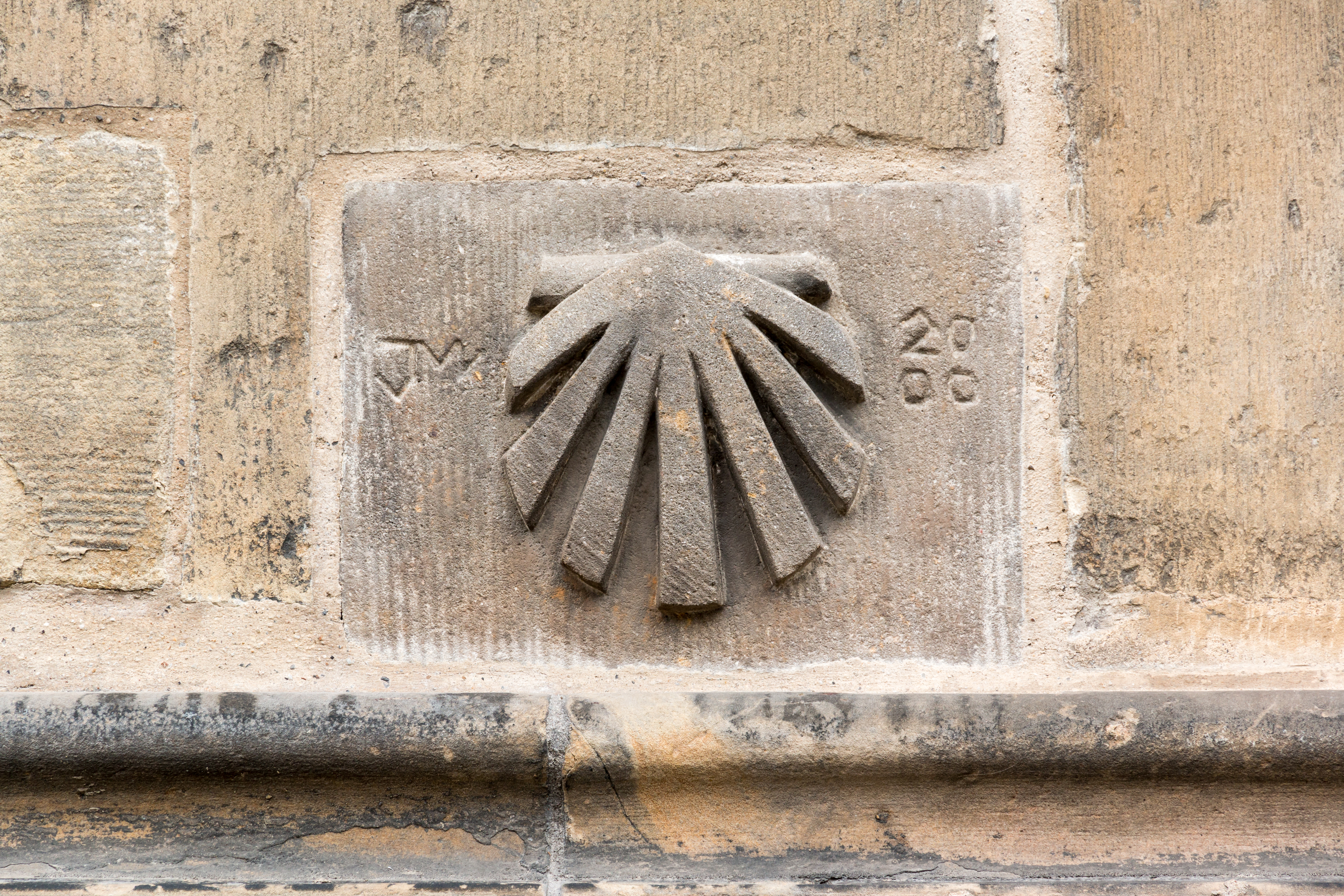 Signs of Way of Saint James at the St. Lamberti Church, Münster, North Rhine-Westphalia, GermanySt. Lamberti is a Roman Catholic parish church in Münster’s old town. It was built between 1375 and 1525 as a market and civic church and is located on Lambertikirchplatz and at the corner of Salzstraße and Prinzipalmarkt. St. Lamberti is the most important sacred building of the Westphalian late Gothic period. It is named after St. Lambert of Liège.A special feature are three iron baskets attached to the tower, in which the bodies of the three leaders of the Anabaptist kingdom of Münster, Jan van Leiden, Bernd Krechting, and Bernd Knipperdolling, were displayed in 1536 after they had been publicly tortured and executed in the square in front of the church.From 9 p. m. to midnight, a tower watchman or watchwoman blows a horn every half hour. The office has existed since 1379.