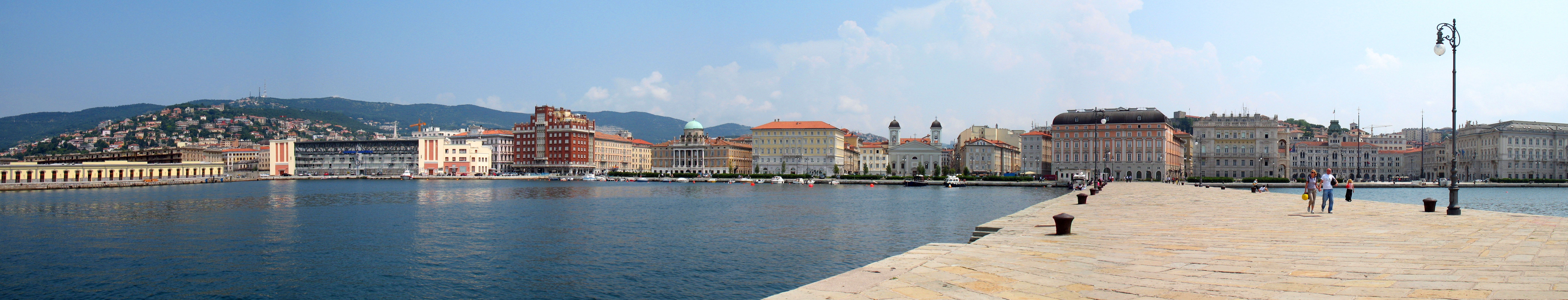 Trieste seafront from the Audace pier: from left to ds. the former Idroscalo (now the Harbor Master's Office), the Aedes Palace, Palazzo Carciotti, Hotel de La Ville, Palazzo del Tommaseo, Greek Orthodox Church, Giuseppe Verdi Theater (back), Palazzo del Governo, Palazzo del Comune (piazza Unità of Italy), Palazzo ex-Lloyd Trieste, now Palazzo della Giunta Regionale del Friuli-Venezia Giulia
