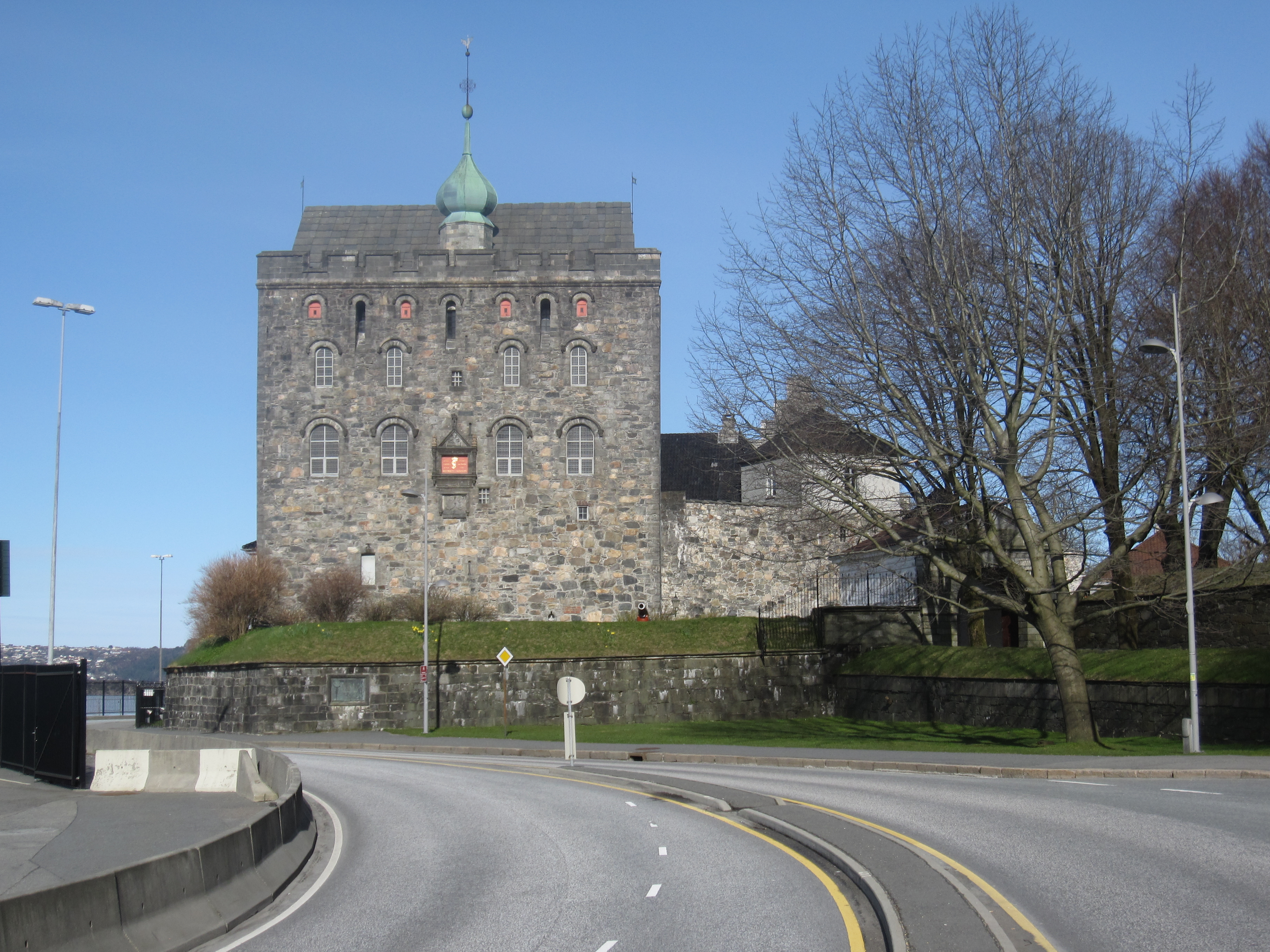 Rosenkrantztårnet (The Rosenkrantz Tower) is a prominent building in Bergenhus Festning, this view is from outside the fortress. 
The tower derives its name from governor Erik Rosenkrantz (1519-1575). It was during his administration the tower received its present shape. The oldest part of the building, however, is made up of a medieval tower, known as the "Keep by the Sea", built by King Magnus IV Håkonsson (aka Magnus the Lawmender) in the 1270s as part of the royal castle in Bergen.

The keep was extensively modified and expanded in the 1560s by Scottish stonemasons and architects in the service of Erik Rosenkrantz. Rosenkrantz' building contained dungeons on the ground floor, residential rooms for the governor higher up and positions for cannons on the top floor. In the 1740s, the tower was converted to a magazine for gunpowder, a function it served until the 1930s. The whole building has been open to the general public since 1966. Today, the tower serves primarily as a tourist attraction.