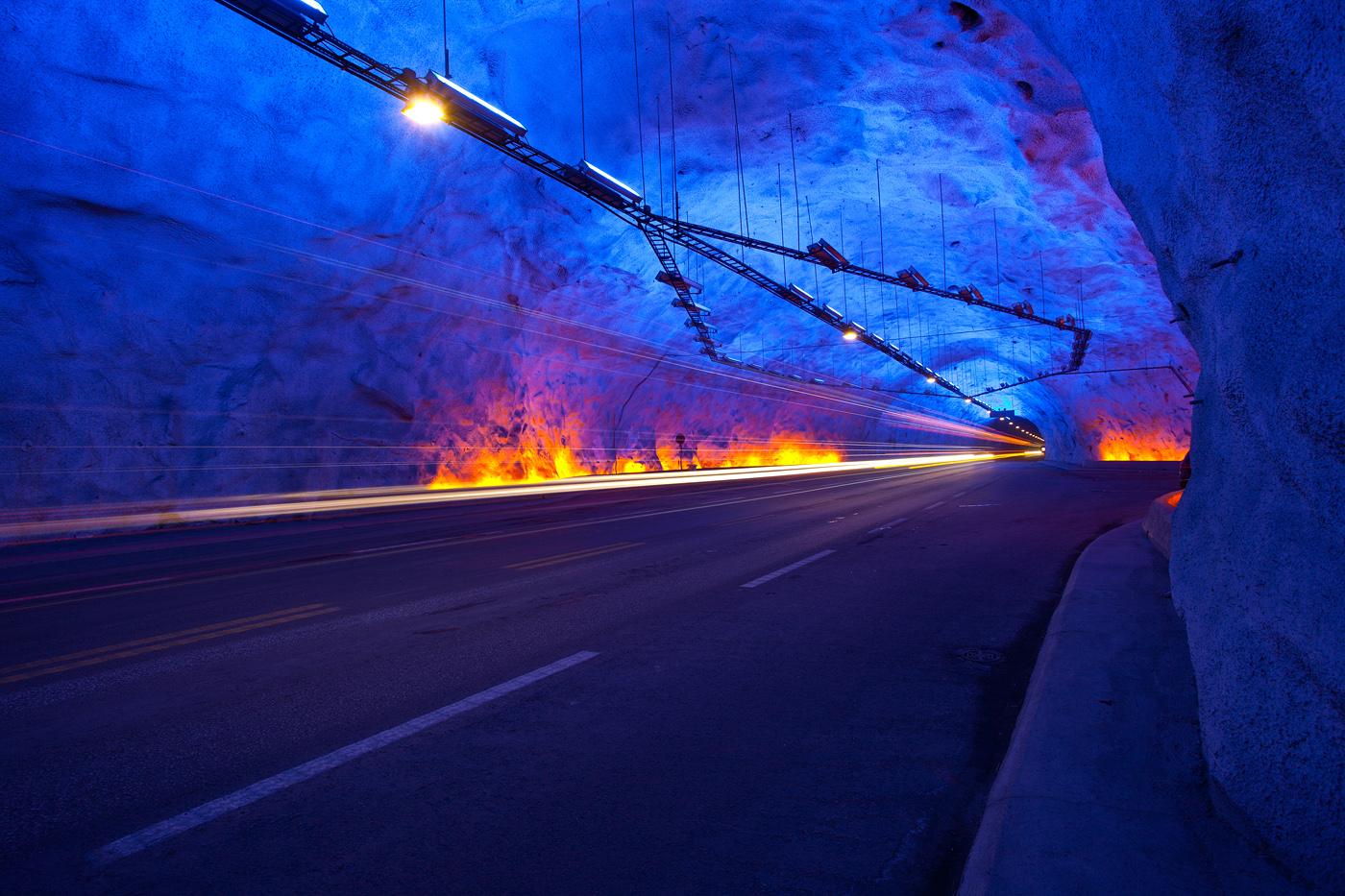 The Lærdalstunnel is the world’s longest road tunnel (24.5 km). The design of the tunnel takes into consideration the mental strain on drivers, so the tunnel is divided into four sections, separated by three large mountain caves (as you can see on this photo). The caves are meant to break the routine, providing a refreshing view and allowing drivers to take a short rest.