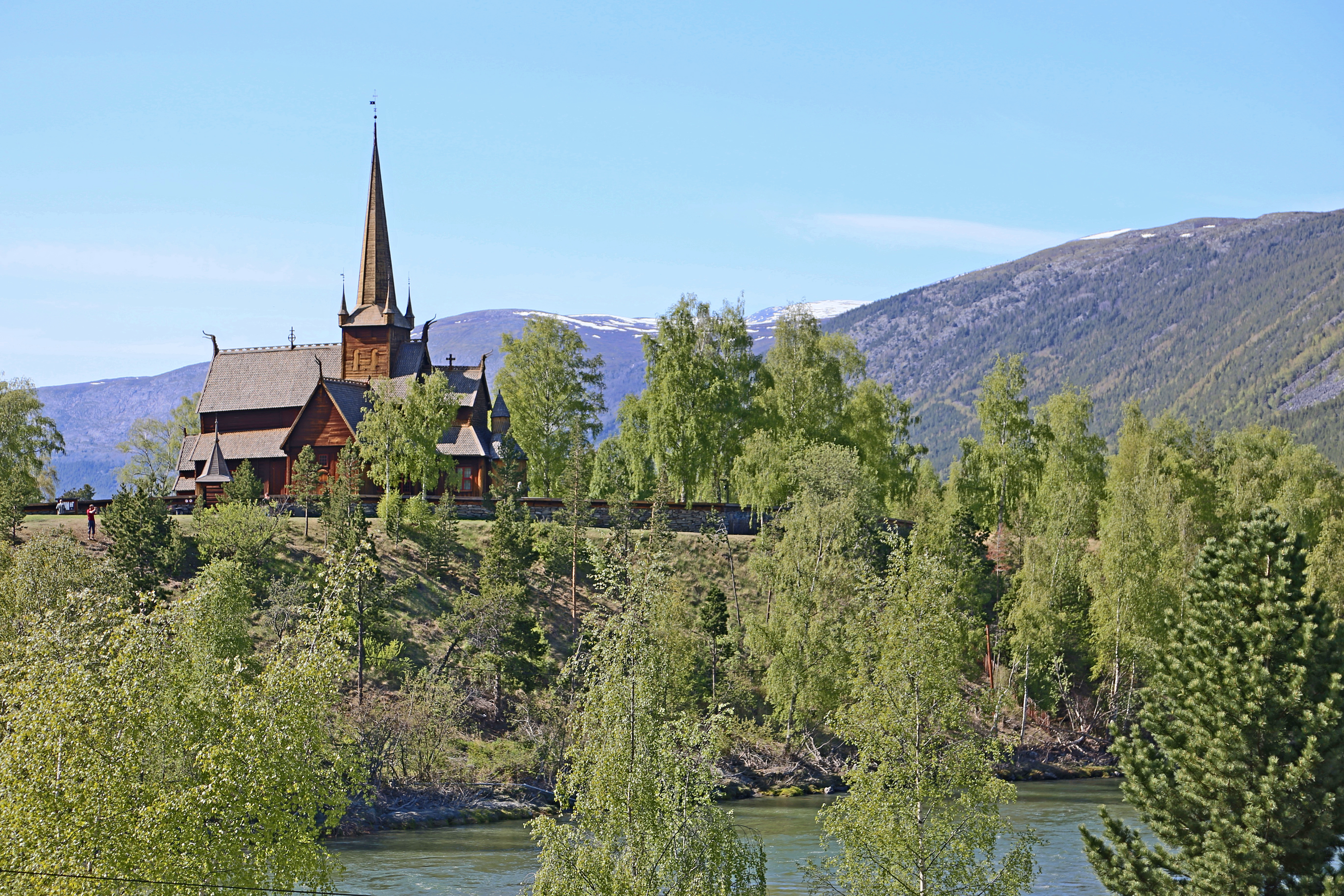 Lom Stave Church. The Lom Evangelical Church is one of the largest stave churches in Norway. It was built in the 12th century. The church is located in the province of Oppland in southwest Norway. In the foreground the river Bøvra.